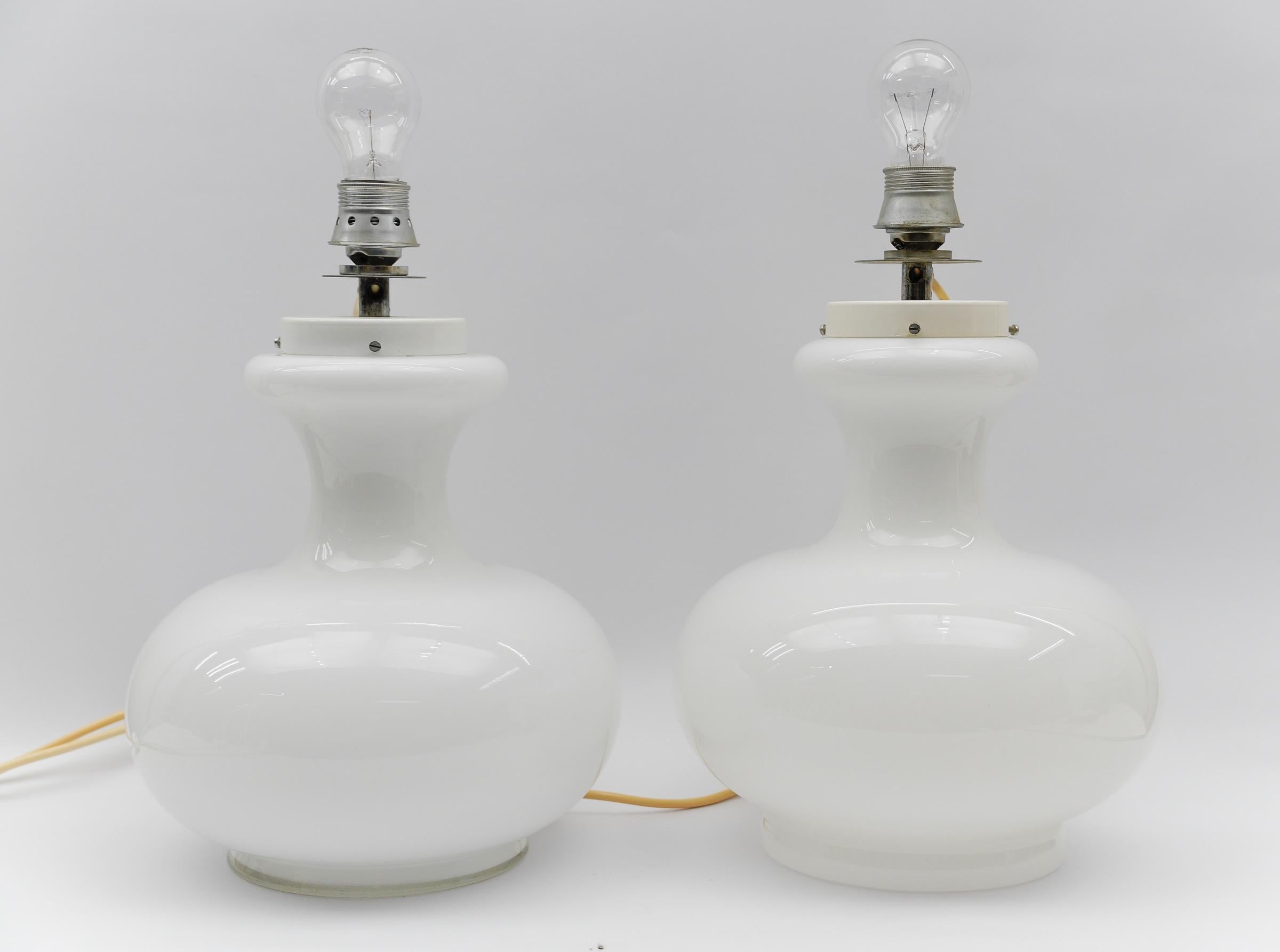 Lovely Pair of Mid-Century Modern Opal Glass Table Lamp Bases, 1960s  

Shipped without bulbs.
Each lamp needs 1 x E27 Edison screw fit bulb, is wired, and in working condition. It runs both on 110 / 230 volt.
The lamp bases are made of opal glass