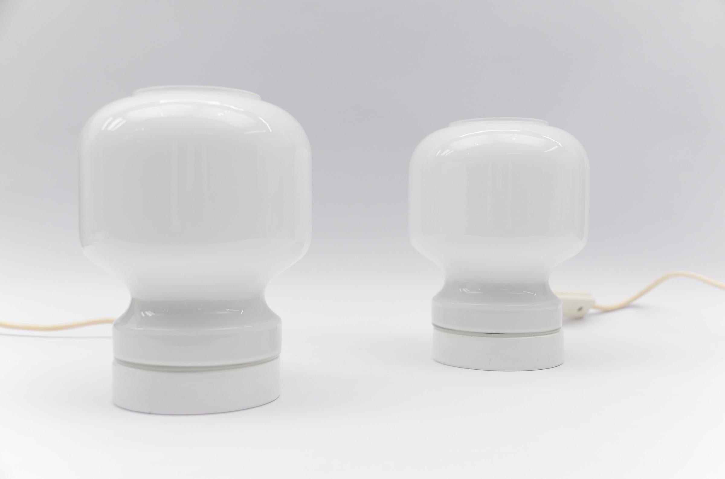 Lovely Pair of Mid-Century Modern Opal Glass Table Lamps, 1960s  

Each lamp needs 1 x E27 Edison screw fit bulb, is wired, and in working condition. It runs both on 110 / 230 volt.

Very elegant and cute at the same time.

Light bulbs are not