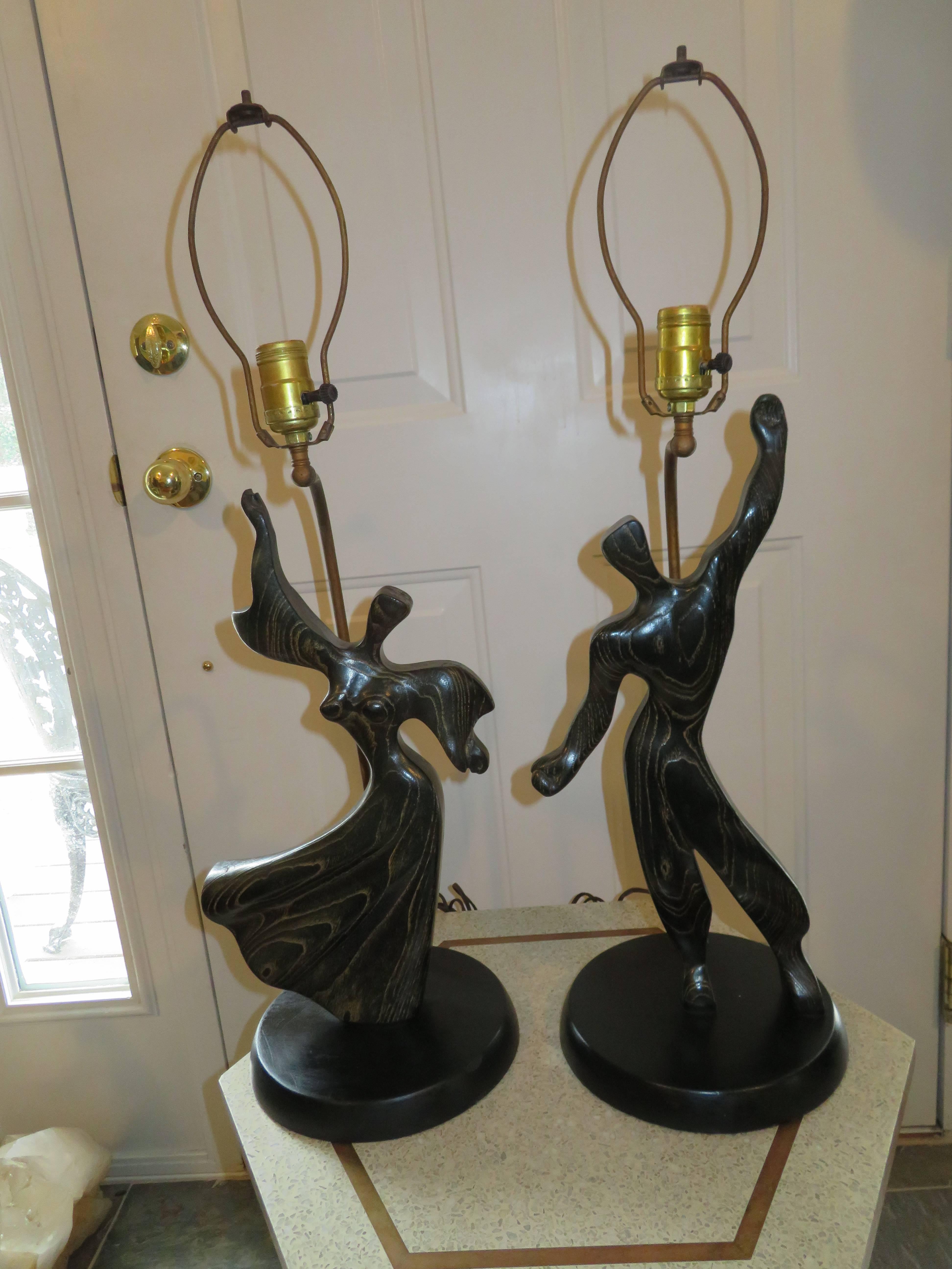 Lovely pair of Heifetz solid oak male or female lamps in a cerused black finish. The designers name is Dorothy Schindele.   Original working condition, lamps have not been altered. Sold as a pair.
Bodies alone are 18 inches tall.