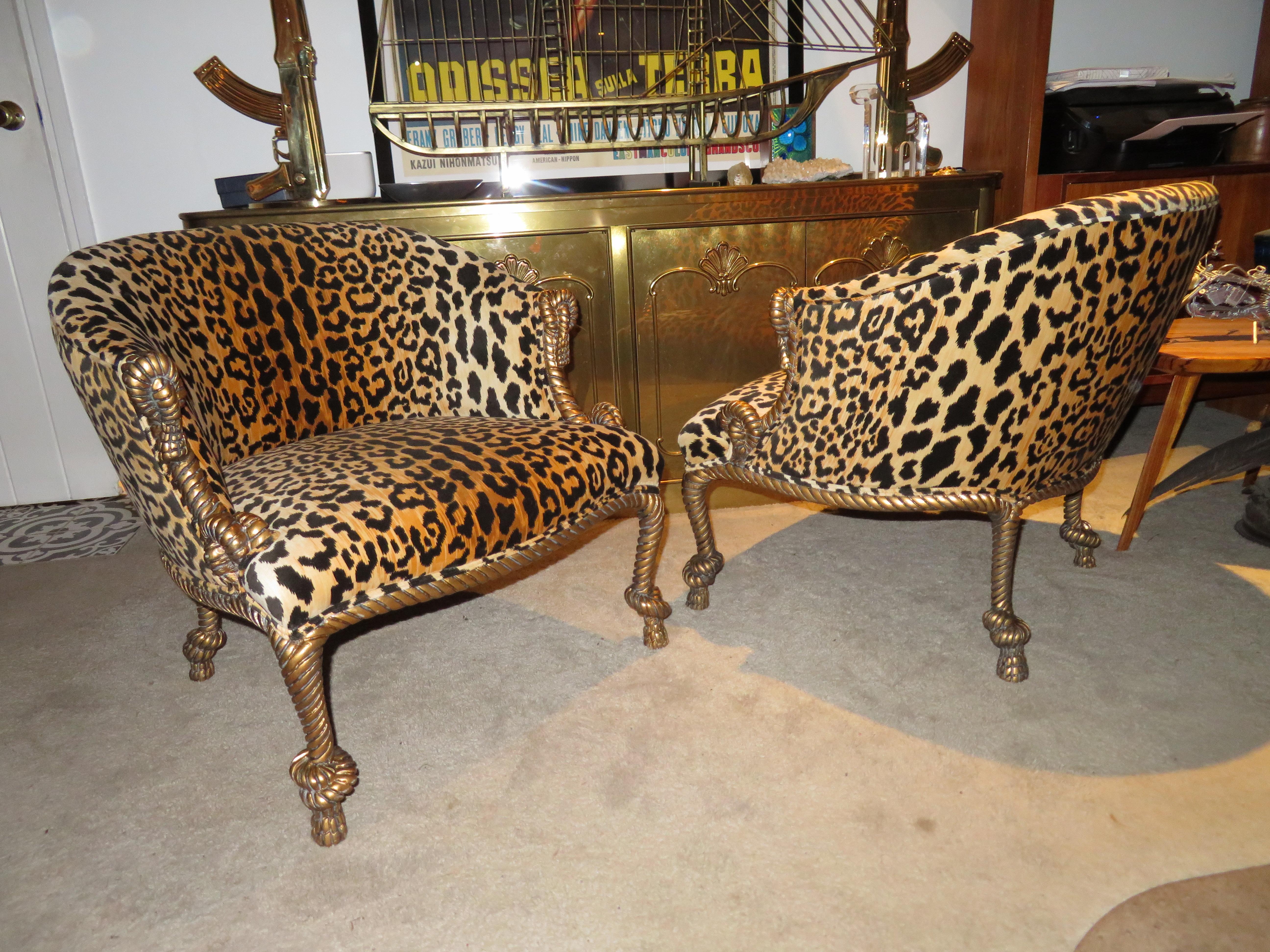 Lovely pair of 1960s Hollywood Regency barrel back armchairs with carved wood rope and tassel motif. These have been freshly re-upholstered in a gorgeous leopard velvet and are stunning in person. Chair size: 28.5 in. H x 26.5 in. W x 27.5 in. D.