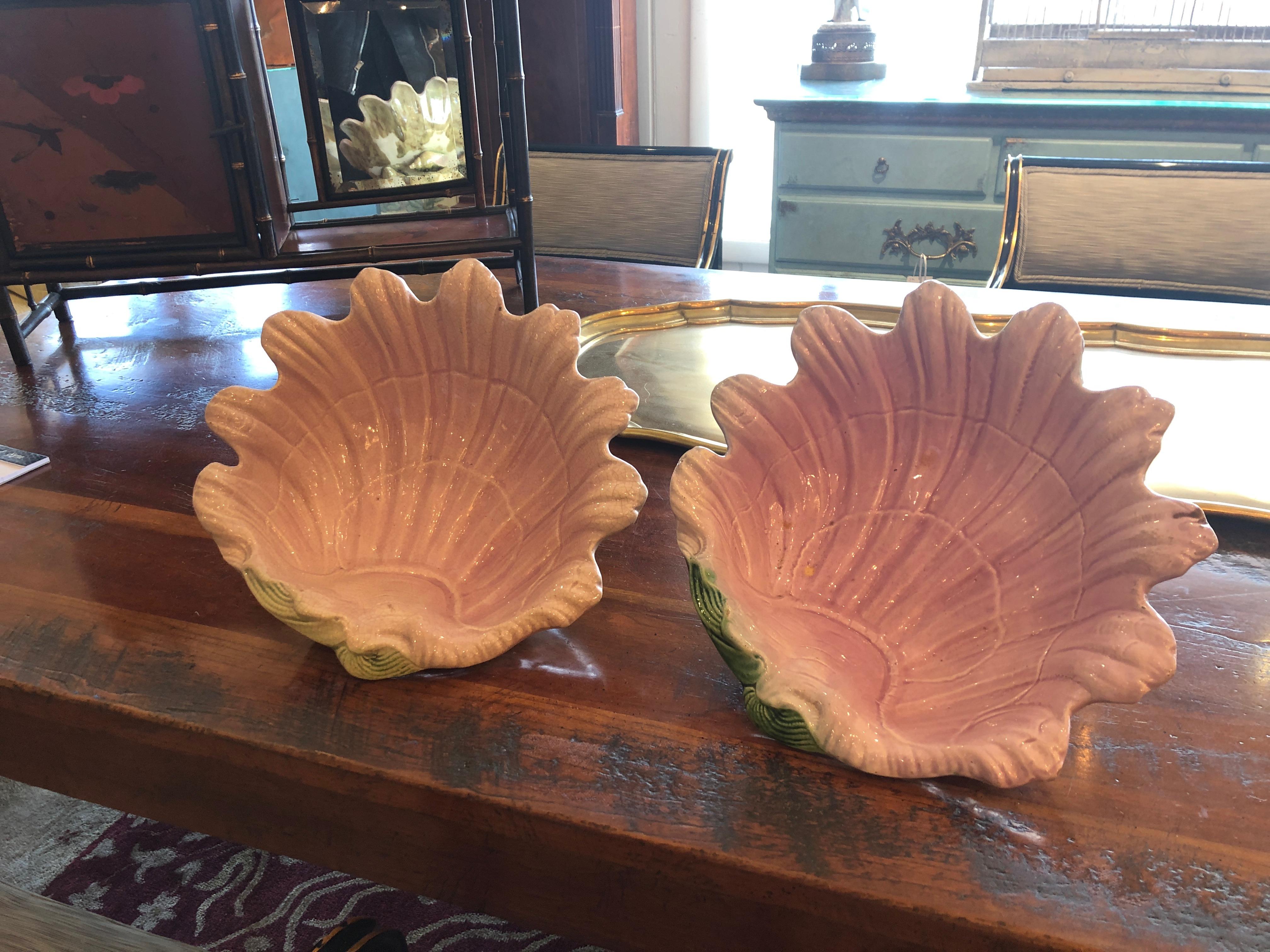 Incredibly pretty pair of Majolica clam shell bowls each in a lovely shade of pink, having undersides in green, white and brown with a trio of wonderful nautilus shell feet.
Not an exact match, each unique.