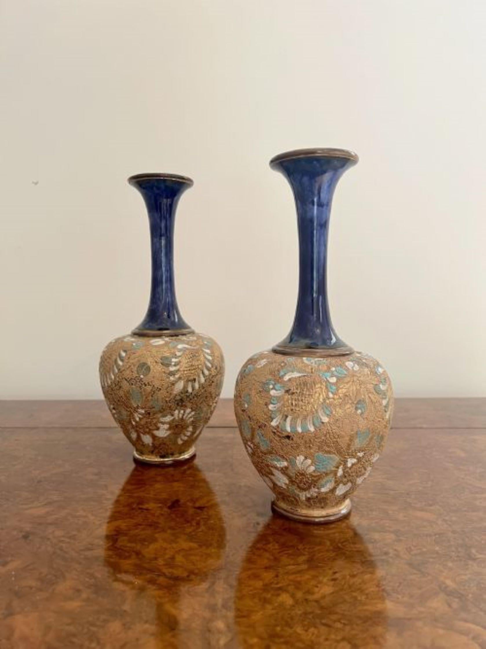 Lovely pair of quality antique Doulton vases having a lovely pair of shaped antique Royal Doulton vases having a band of green, blue and white flowers on a golden background to the centre of the vase and a dark blue glaze to the rest of the vase.