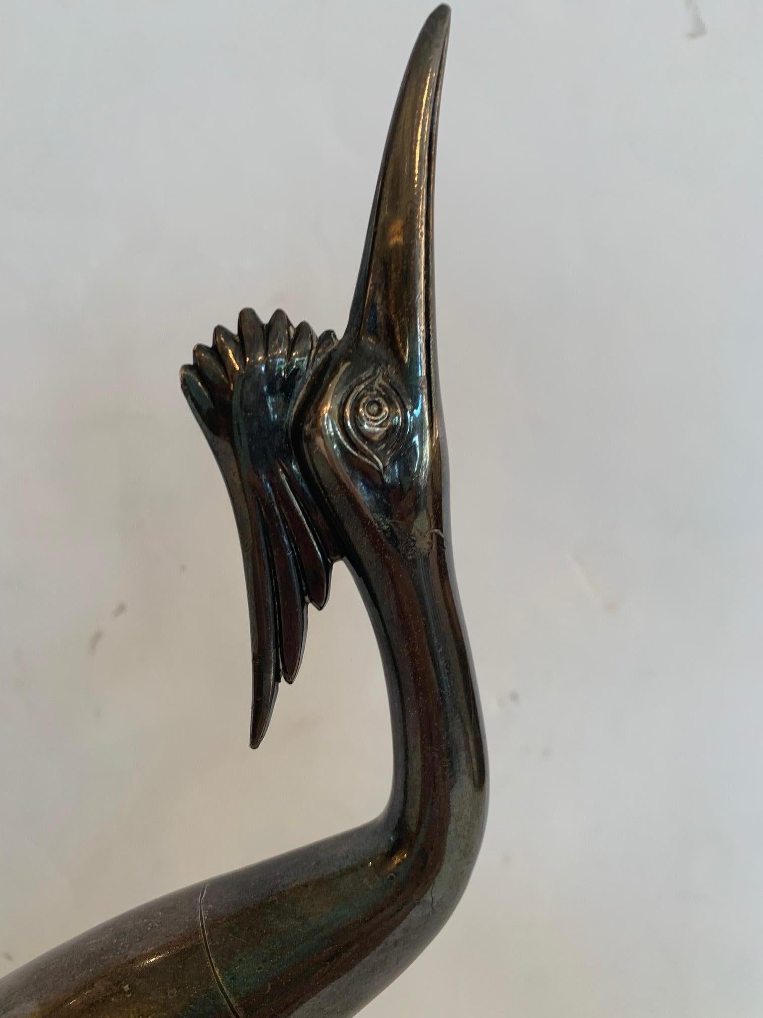Beautiful pair of silverplated egrets in lovely positions, one with beak upturned, the other looking away.

Lg bird 16” H x 4.5” W x 7” D
Sm bird 11” H x 4” W x 11” D.