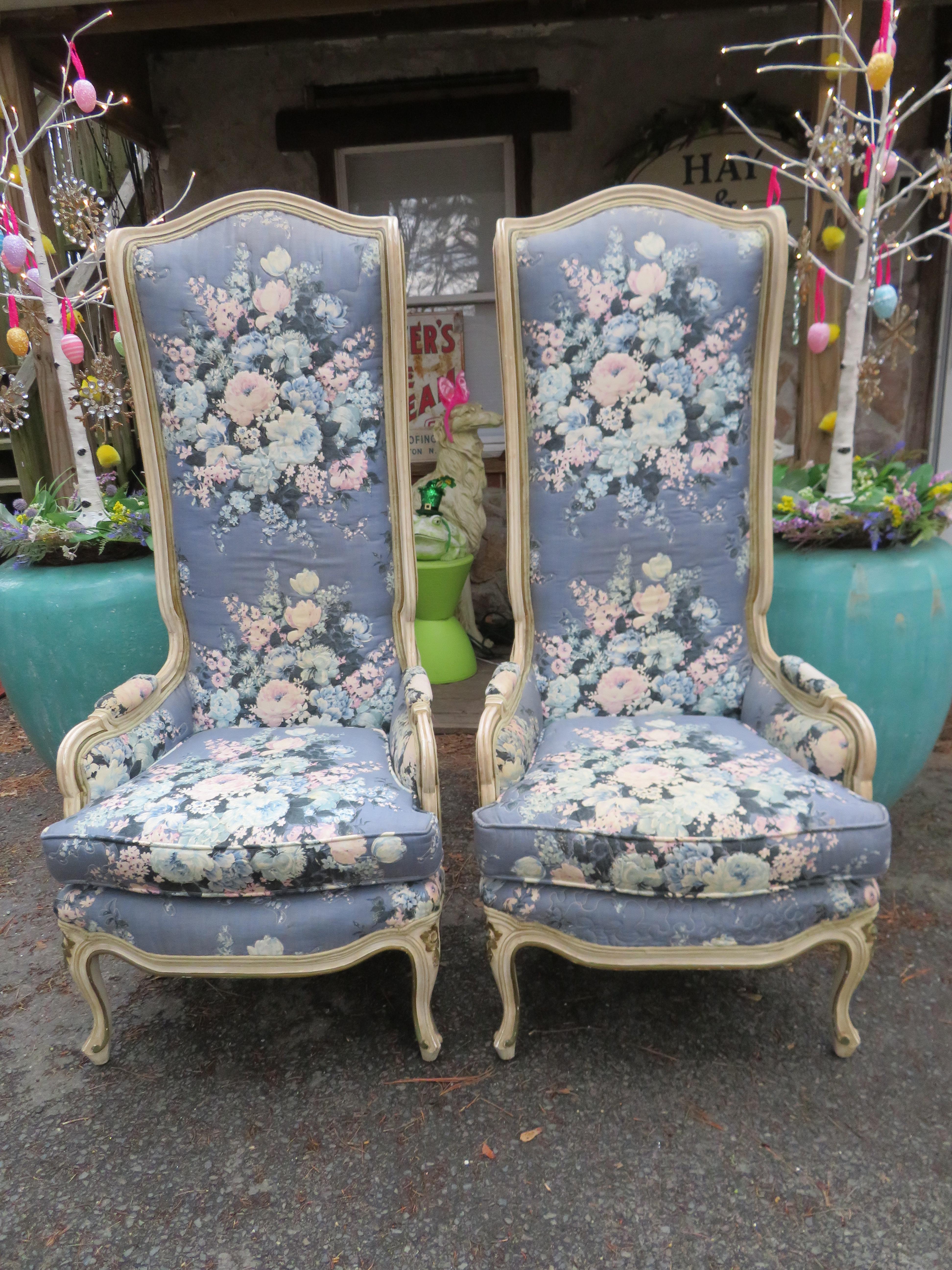 Lovely pair of statuesque French country wingback chairs. We love nothing more than a pair of super tall wingback chairs. We also love the original fabric on these with the lavender floral quilted fabric on the inside and the distressed celery green
