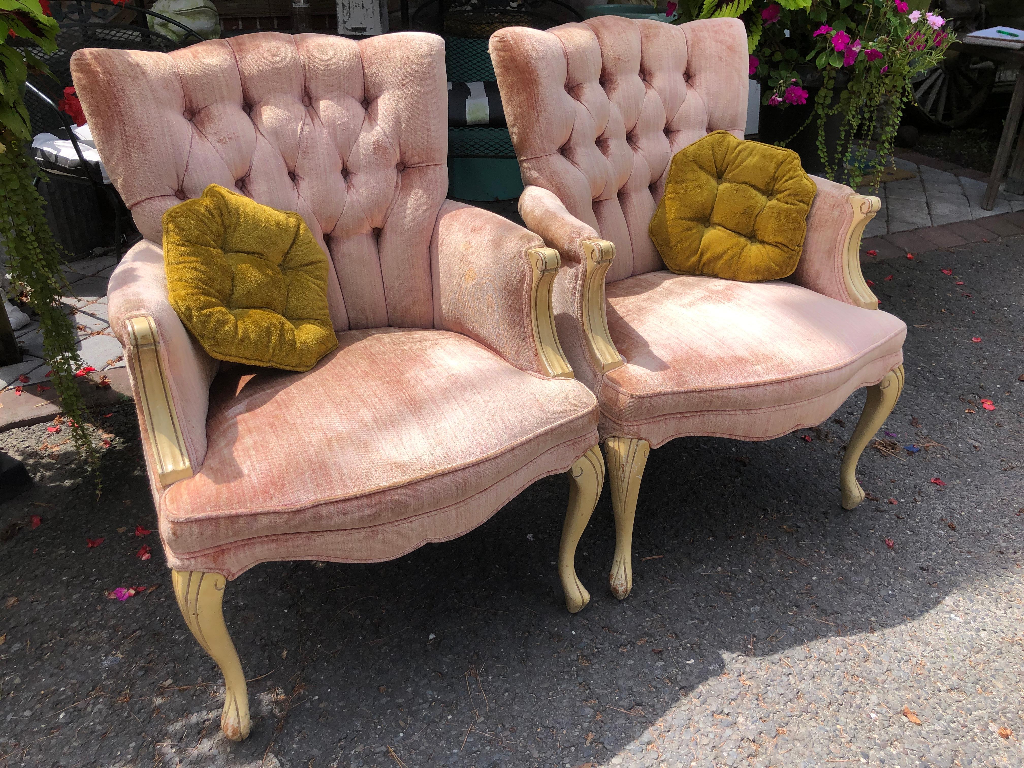 Lovely pair of French Provincial Dorothy Draper style tufted upholstered armchairs.  The legs and arm details have a distressed yellow glazed finish which gives the chair a charming vintage vibe.  These will need to be reupholstered as the original