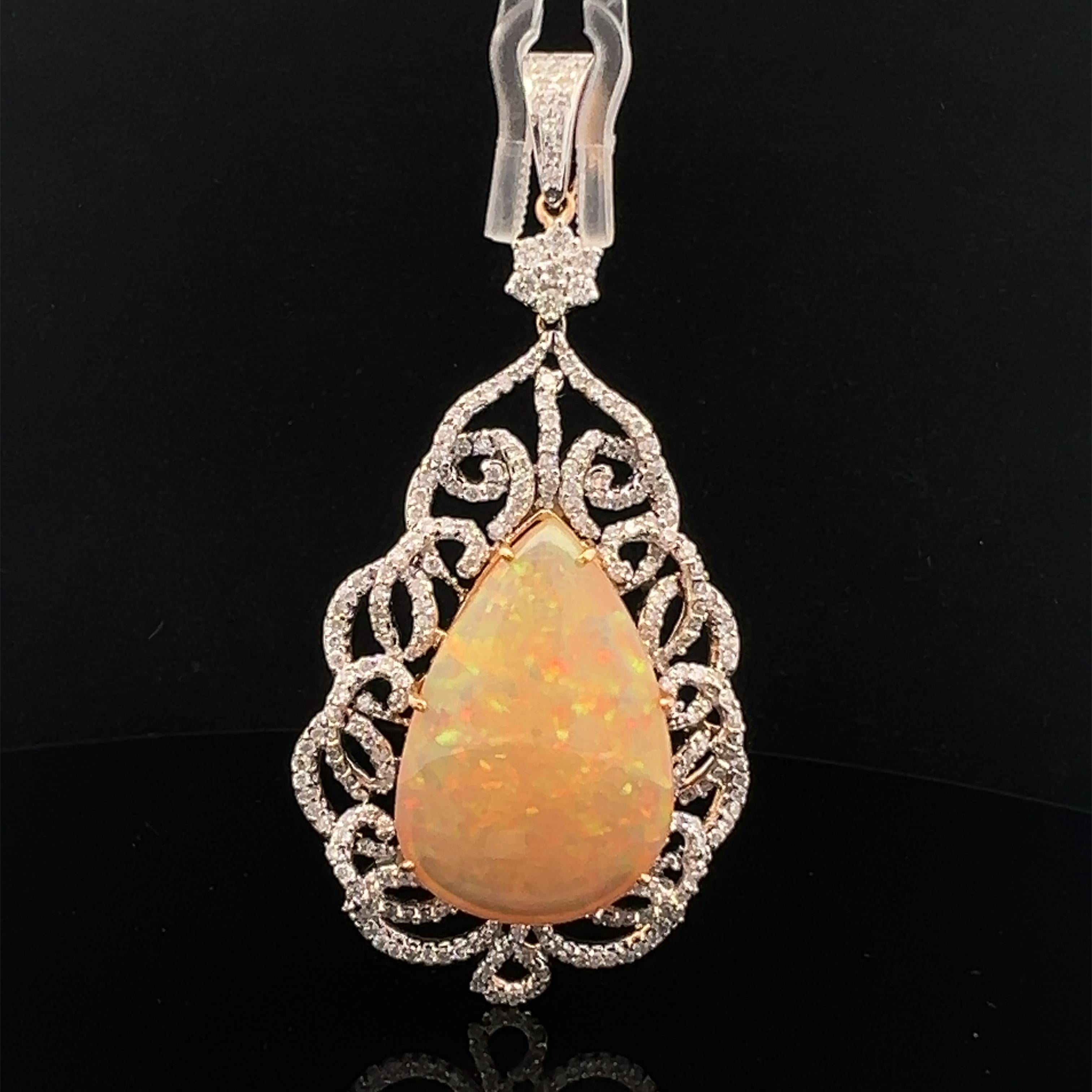 Featuring 2.37 carats of diamonds and 24.76 carats of opal set in an 18-karat gold pendant, the whole thing is pretty stunning. 

With its mesmerizing color play, the teardrop-shaped opal in this gorgeous pendant attracts the eye. Its beautiful gold