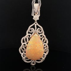Lovely pendant made of natural opal and diamonds in gold.