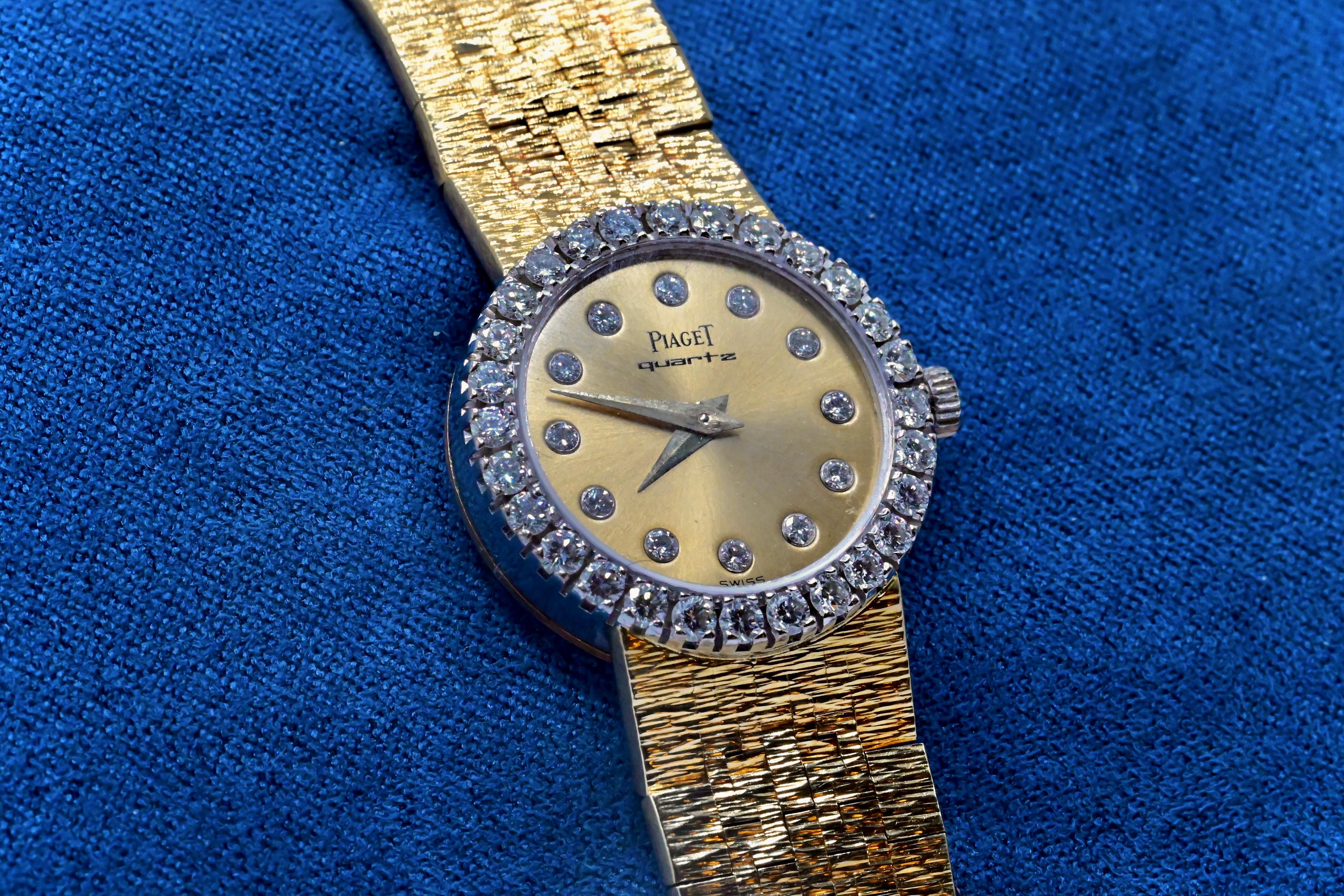This is a stunning ladies Piaget wristwatch made with 18k yellow & white gold. The bezel of the watch is encrusted with 28 exceptional high quality round cut diamonds, and has 12 round cut diamonds placed as time markers. The strap length is 6 1/2