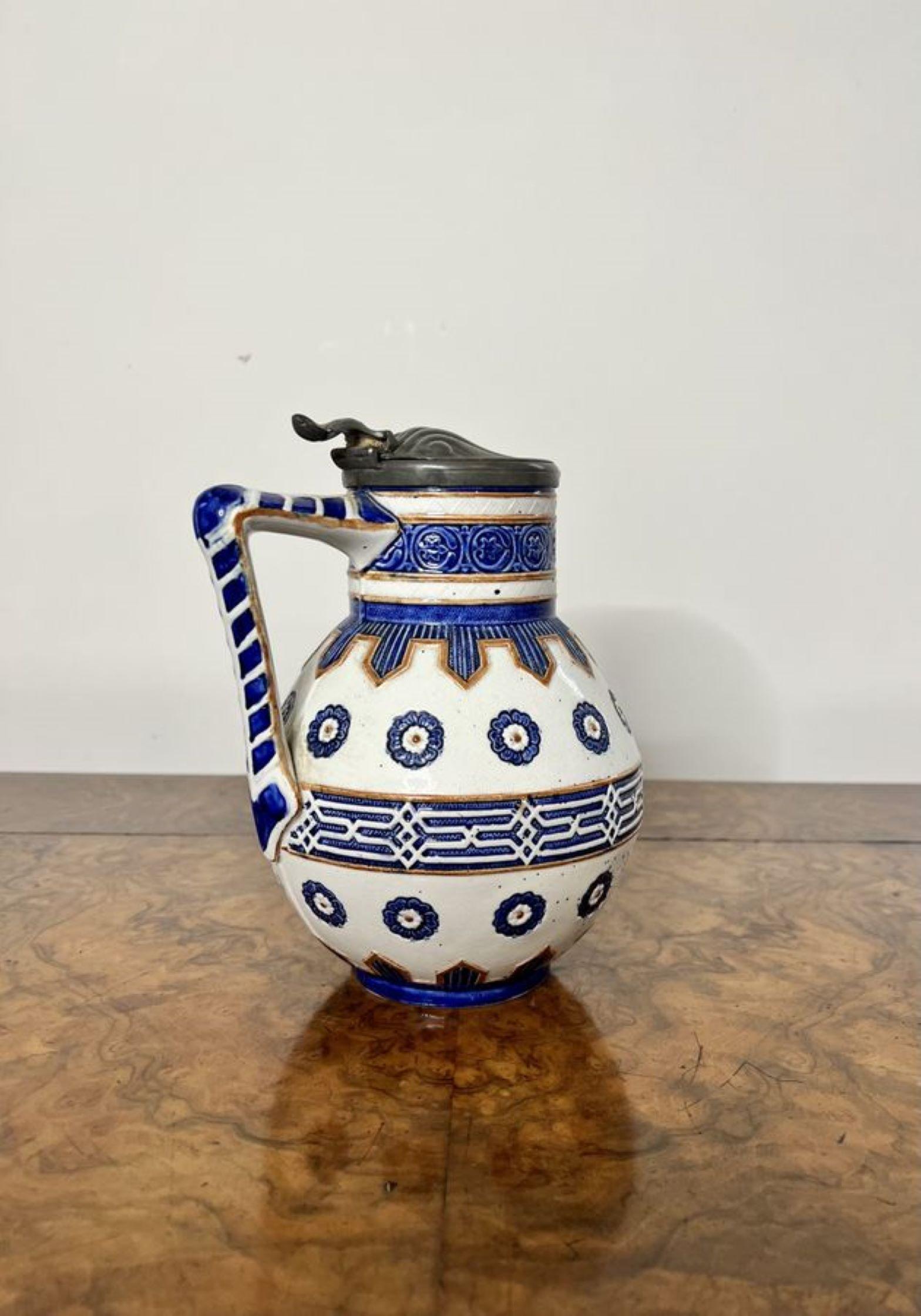 Lovely quality antique Victorian majolica jug, decorated in blue and white colours with a shaped handle to the back and the original pewter lidded top.

D. 1880