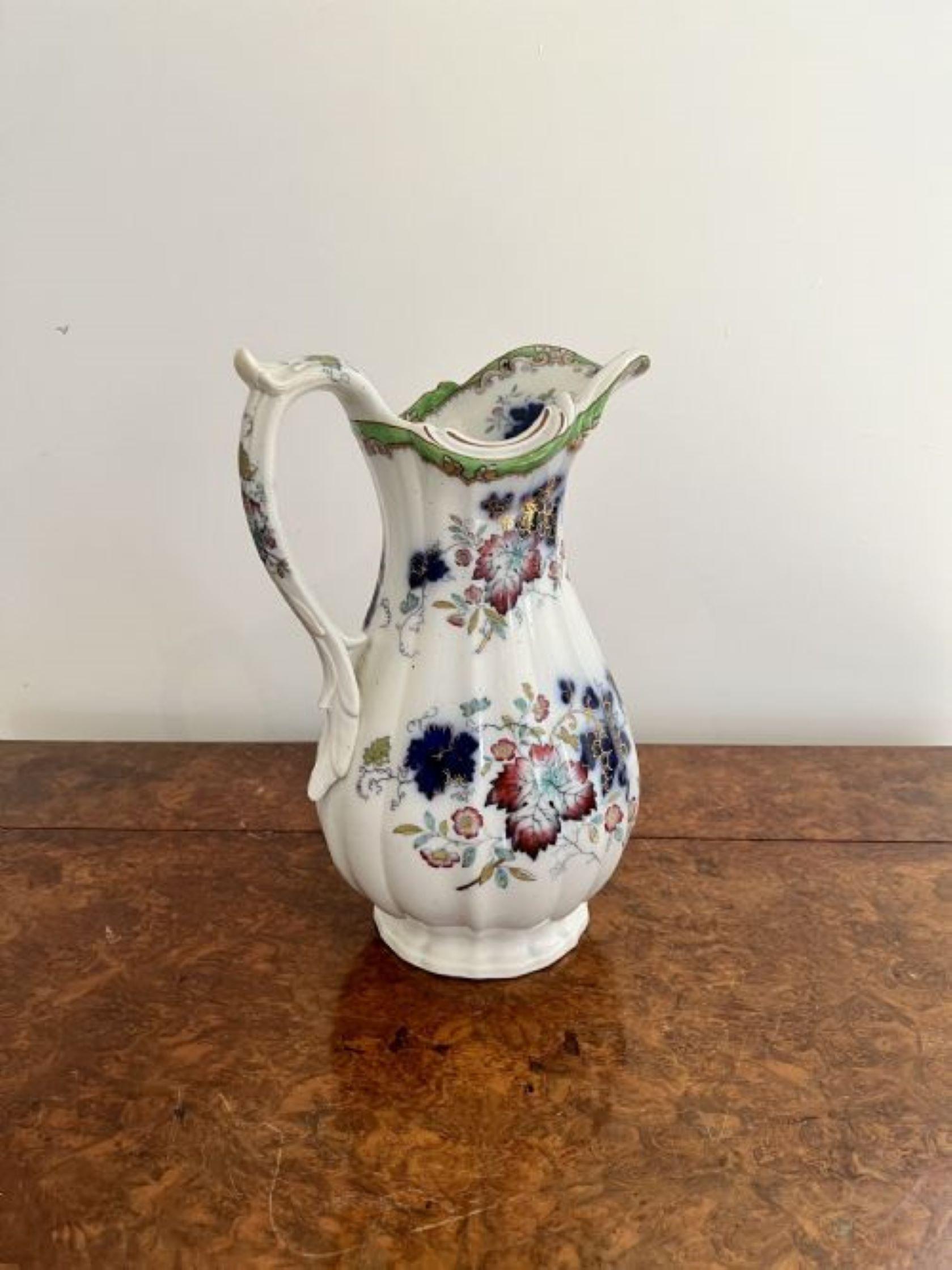 Lovely quality antique Victorian jug and bowl set having a quality antique jug and bowl set with wonderful decoration of flowers and leaves in fantastic red, yellow, green, blue, pink and gold colours with a gilded edge and a shaped handle to the