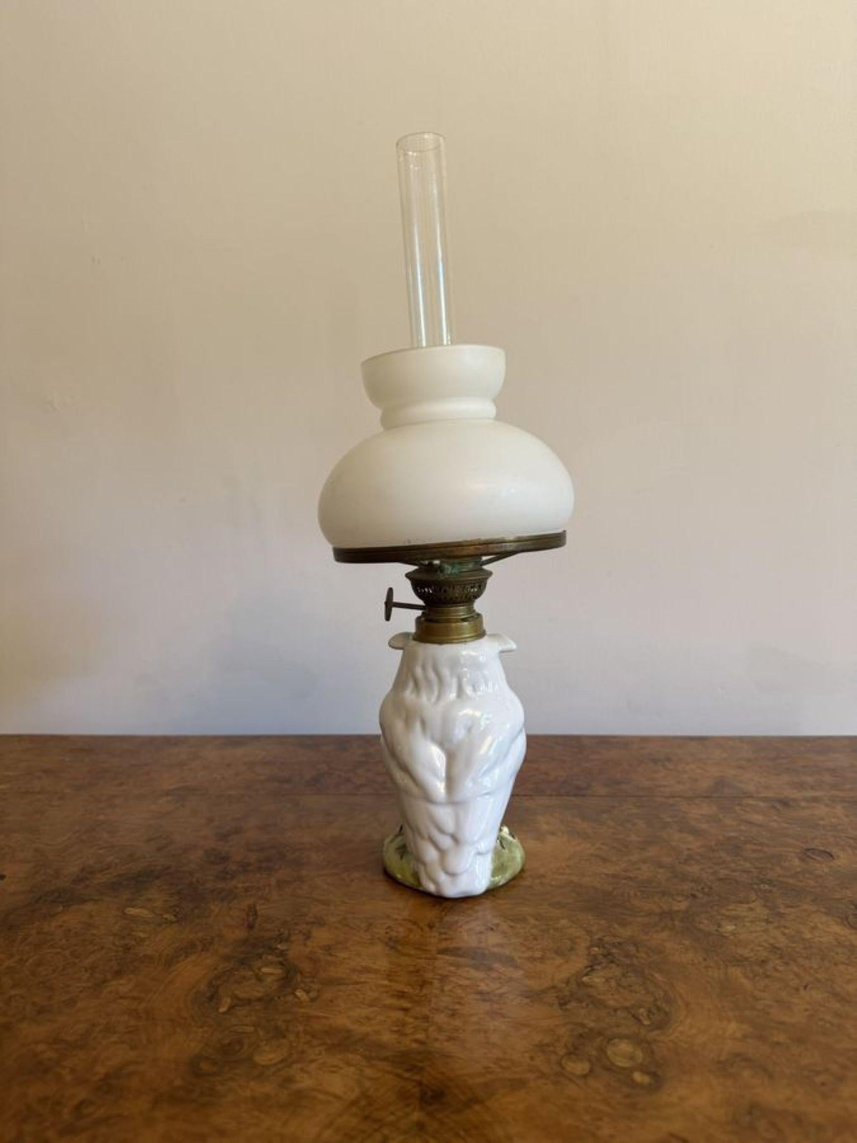 Lovely quality antique Victorian porcelain owl oil lamp, having the original white glass shade above a porcelain figure of an owl above a circular shaped base decorated with leaves. 

D. 1890 