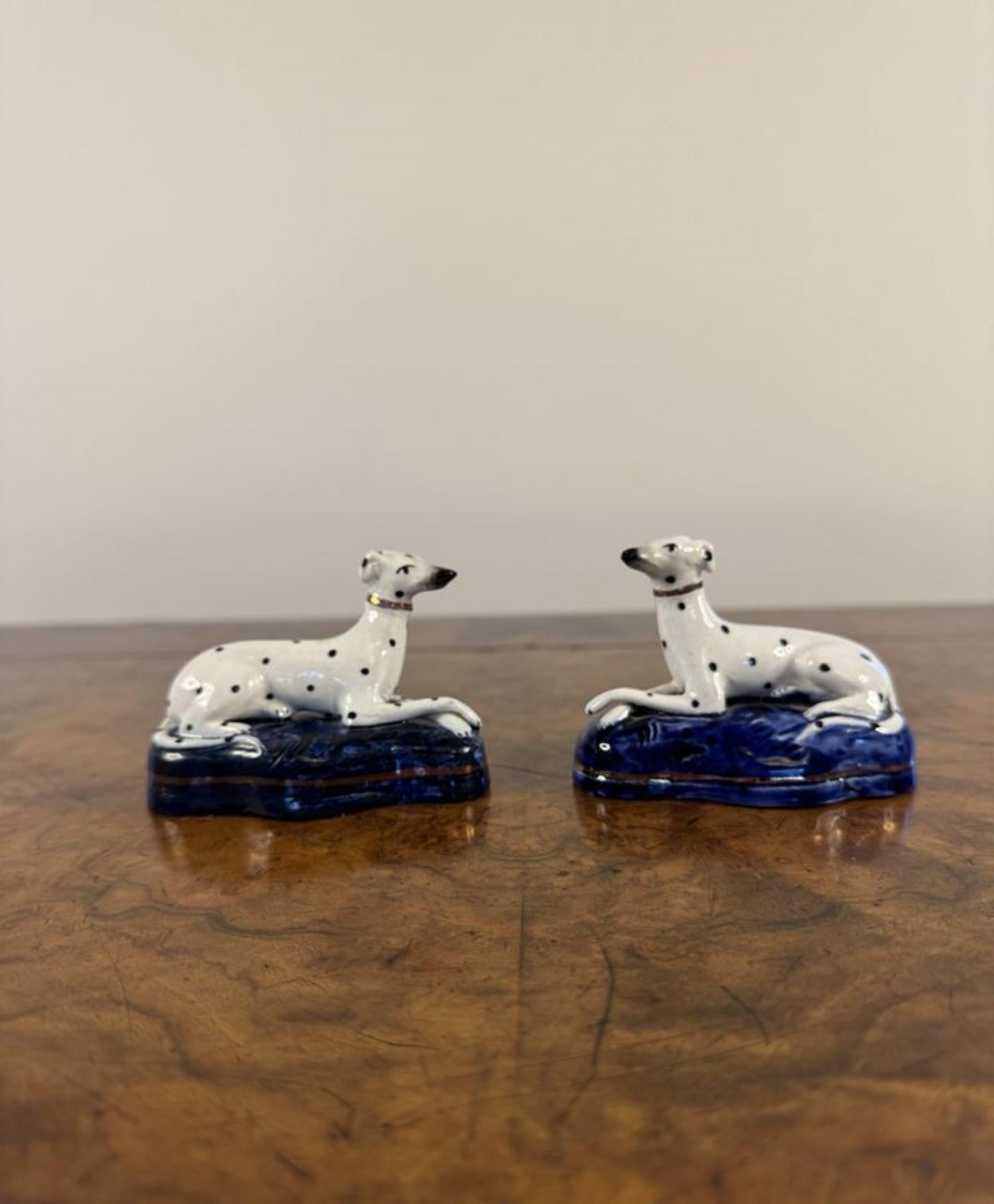 Lovely quality pair of antique Victorian Staffordshire Dalmatians, having a lovely quality pair of antique Victorian Staffordshire Dalmatians with white coats and black spots with matching gold colours sitting on shaped blue gilded bases. 

D. 1850