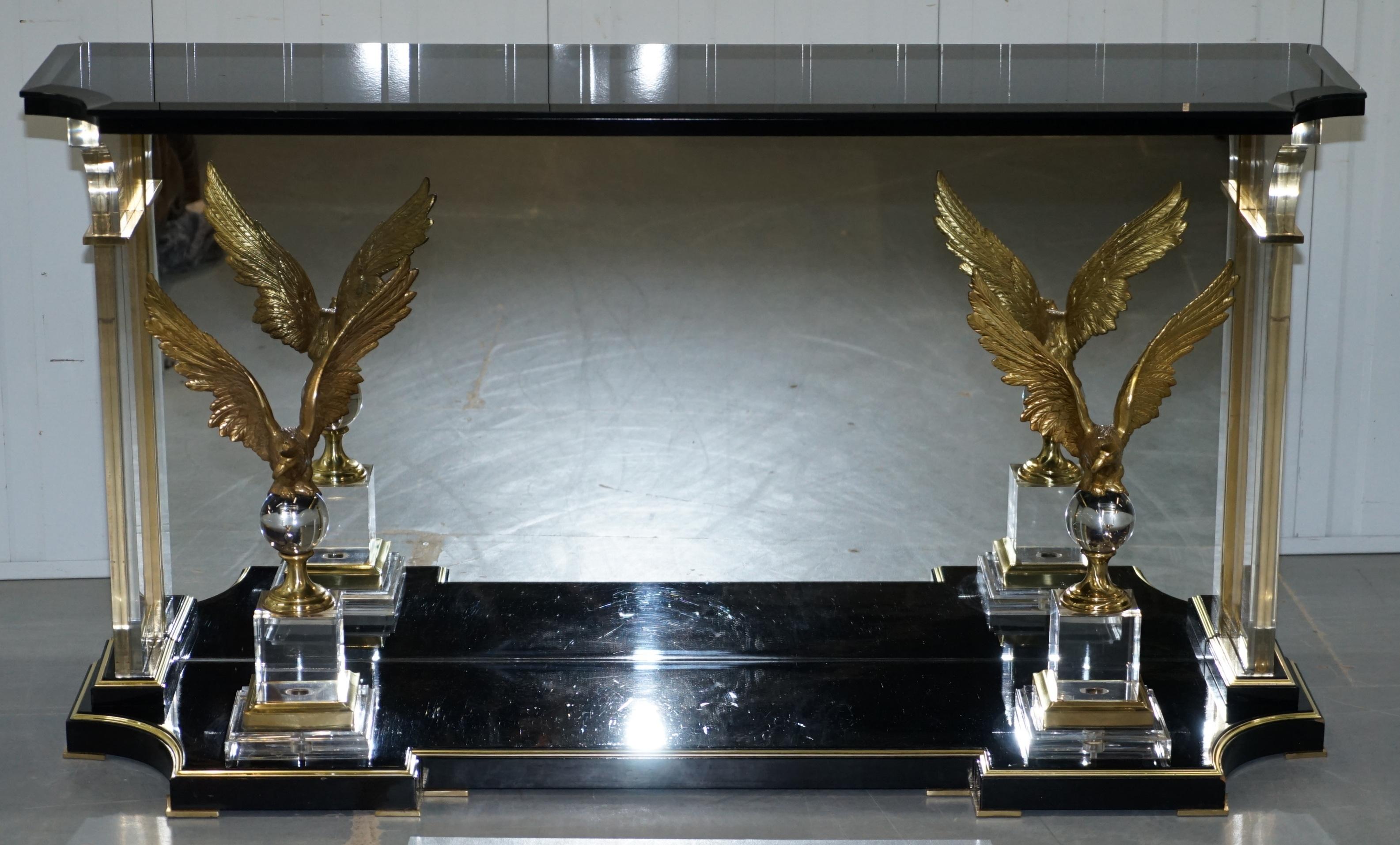 Wimbledon-Furniture is delighted to offer forsale this rare vintage Lucite console table with bronzed eagles and mirrored back

Please note the delivery fee listed is just a guide, it covers within the M25 only, for an accurate quote please send