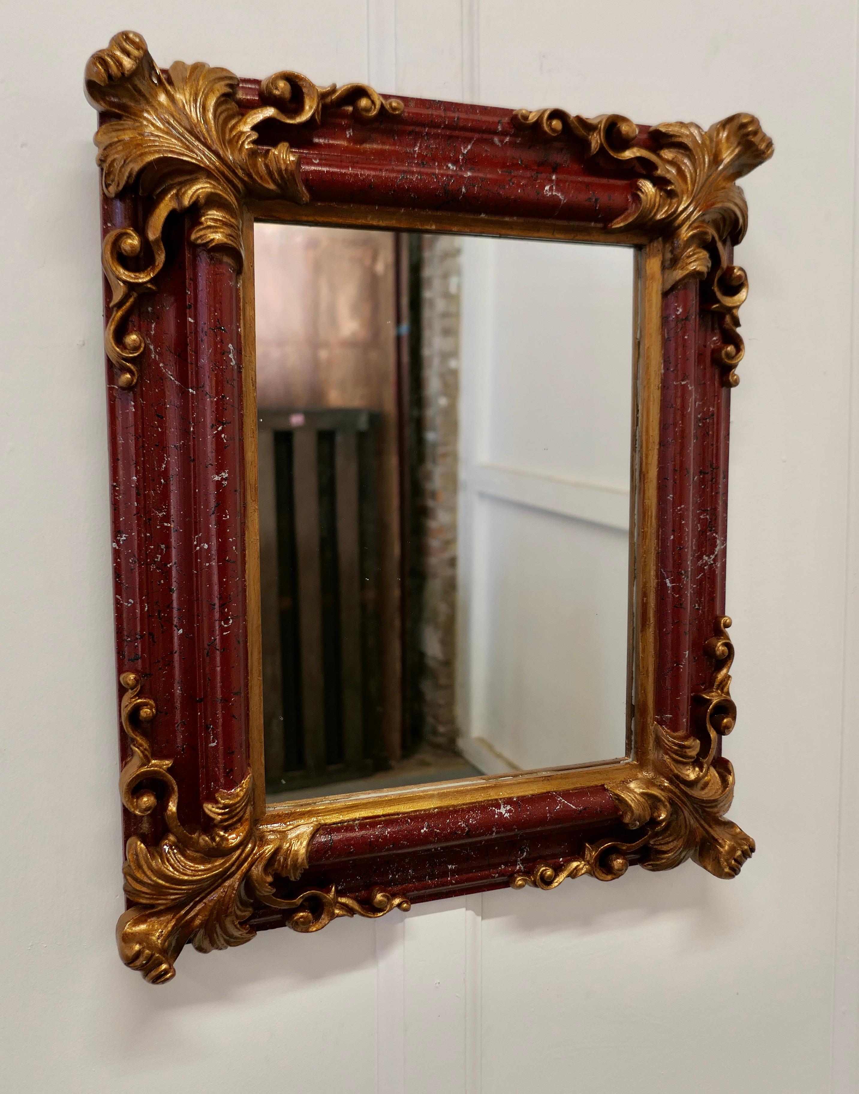 Lovely Rococo Simulated marble wall mirror

The mirror is in a Rococo Style Frame, it is almost square in shape with a 4” wide frame painted to look like Rosa Levante marble with gilded corners
This is a beautiful piece
and in good condition for