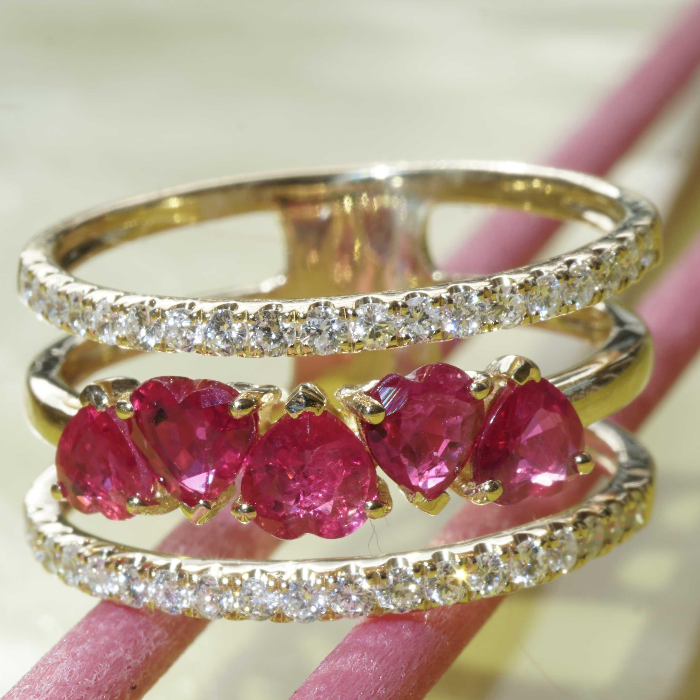 each heart for a special occasion or just beautiful to look at 5 raspberry colored ruby hearts total approx. 1.20 ct in beautiful quality, as if floating set in triple split ring, the side ring rails set with 38 full cut diamonds total approx. 0.40