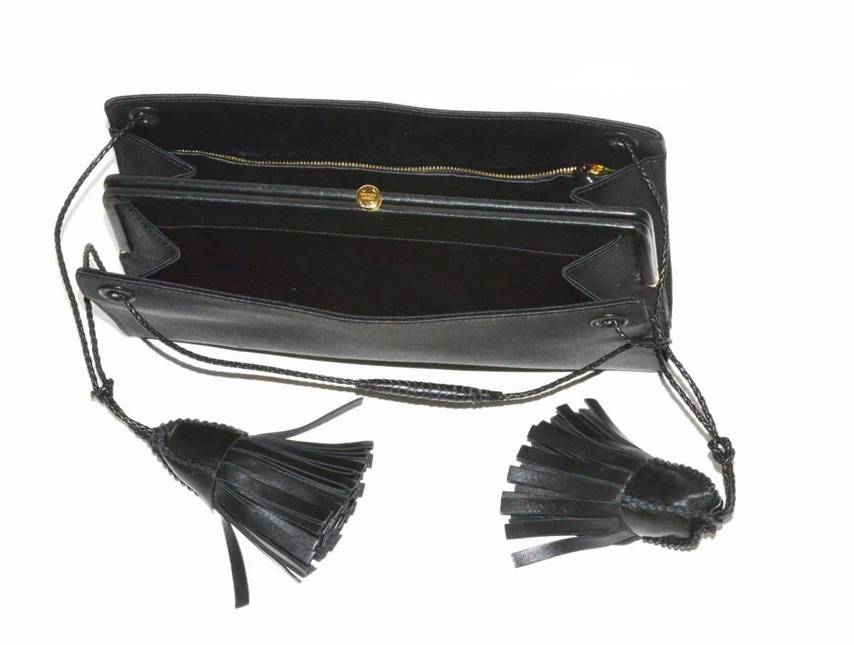 Lovely Bottega! The perfect size in black satin with leather fringe accents. Pristine condition.