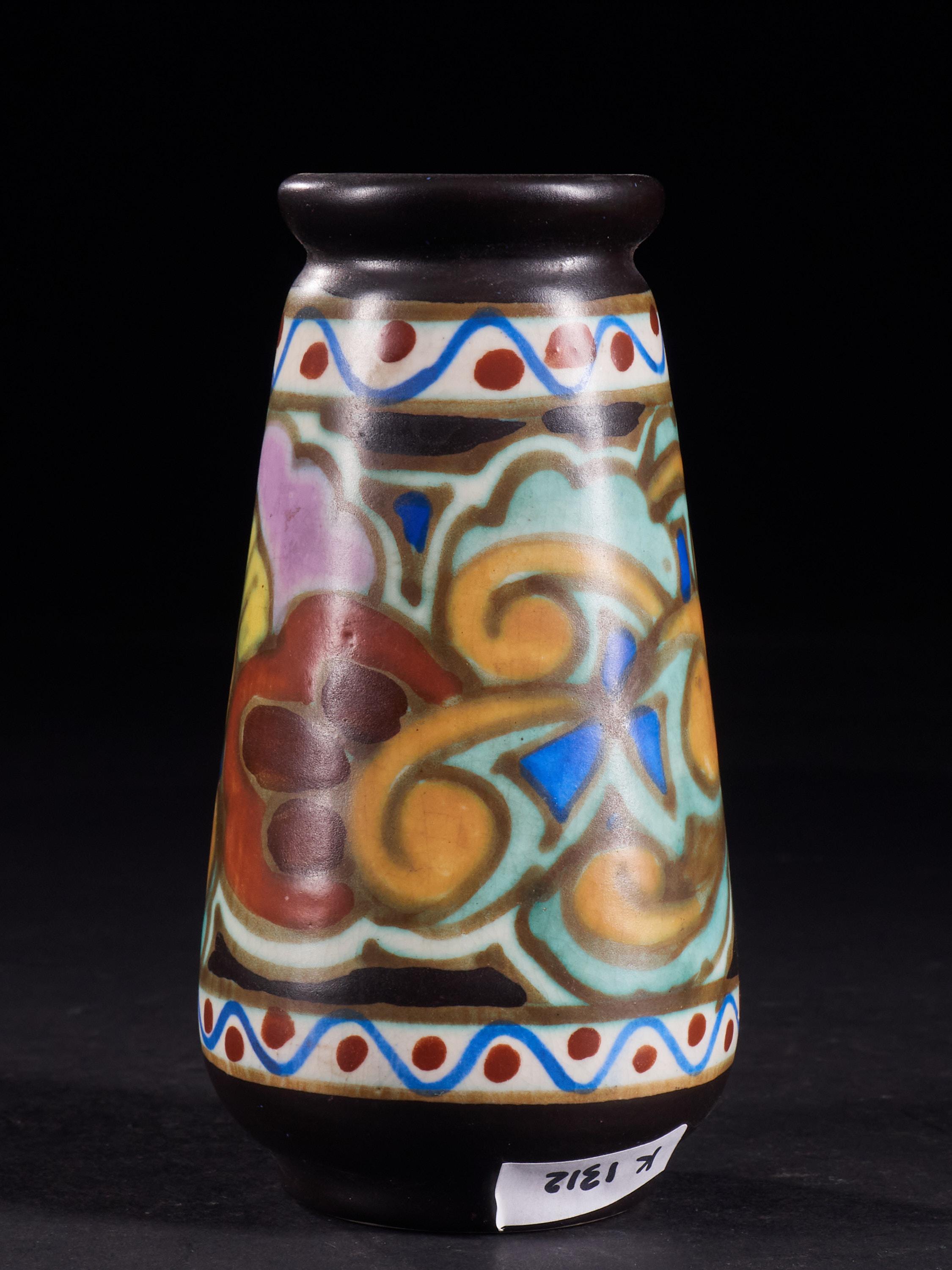 Strikingly original set of 2 colourful ceramic vases with slightly abstract hand painted floral designs and a grainy matte glaze. Tags on the bottom: 1718 C.M. BEREEN / 650.