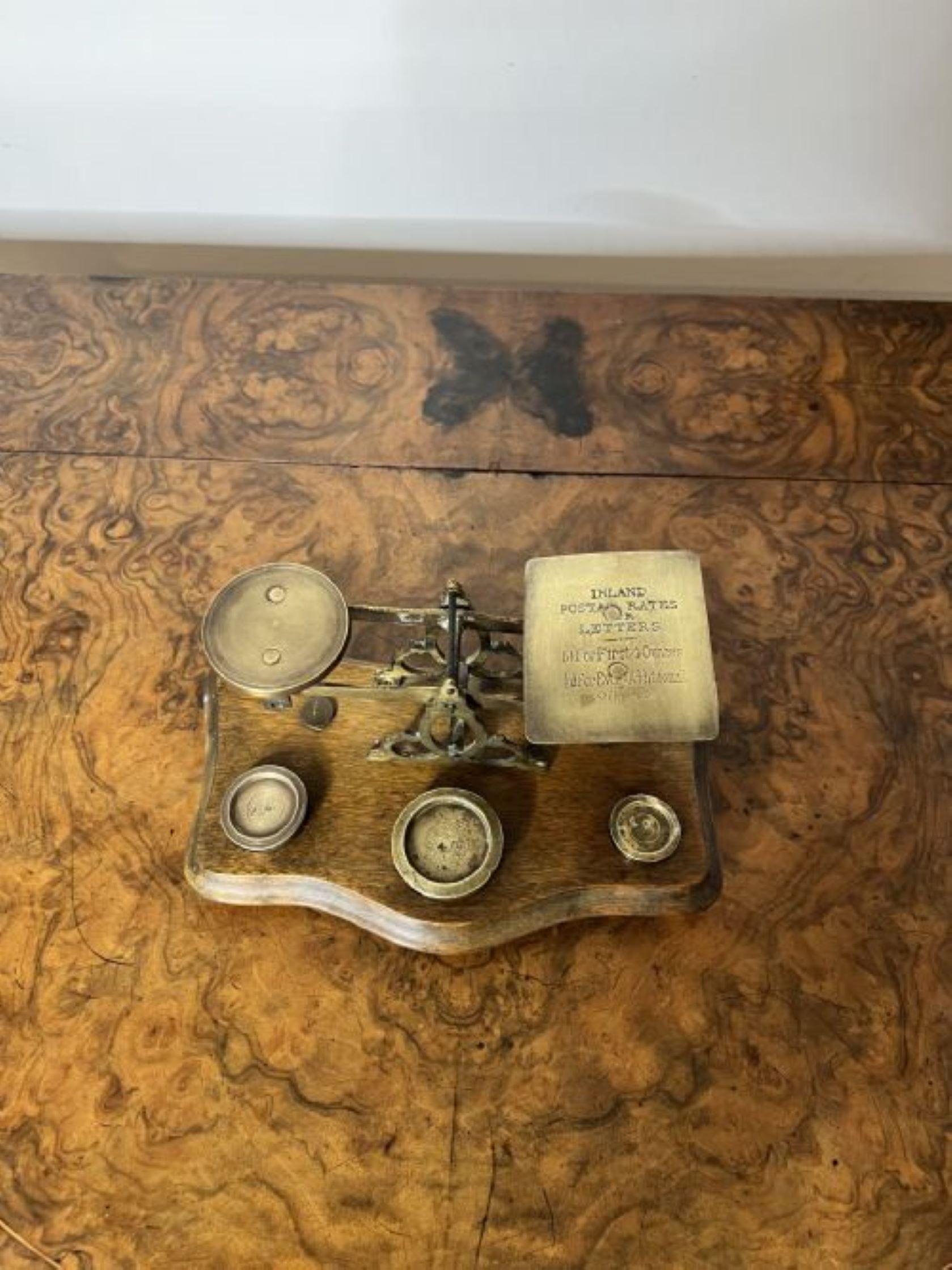 Lovely pair of antique Victorian quality brass Irish postal scales having a lovely pair of antique Victorian brass postal scales with brass weights mounted on a wooden shaped base.

D. 1880