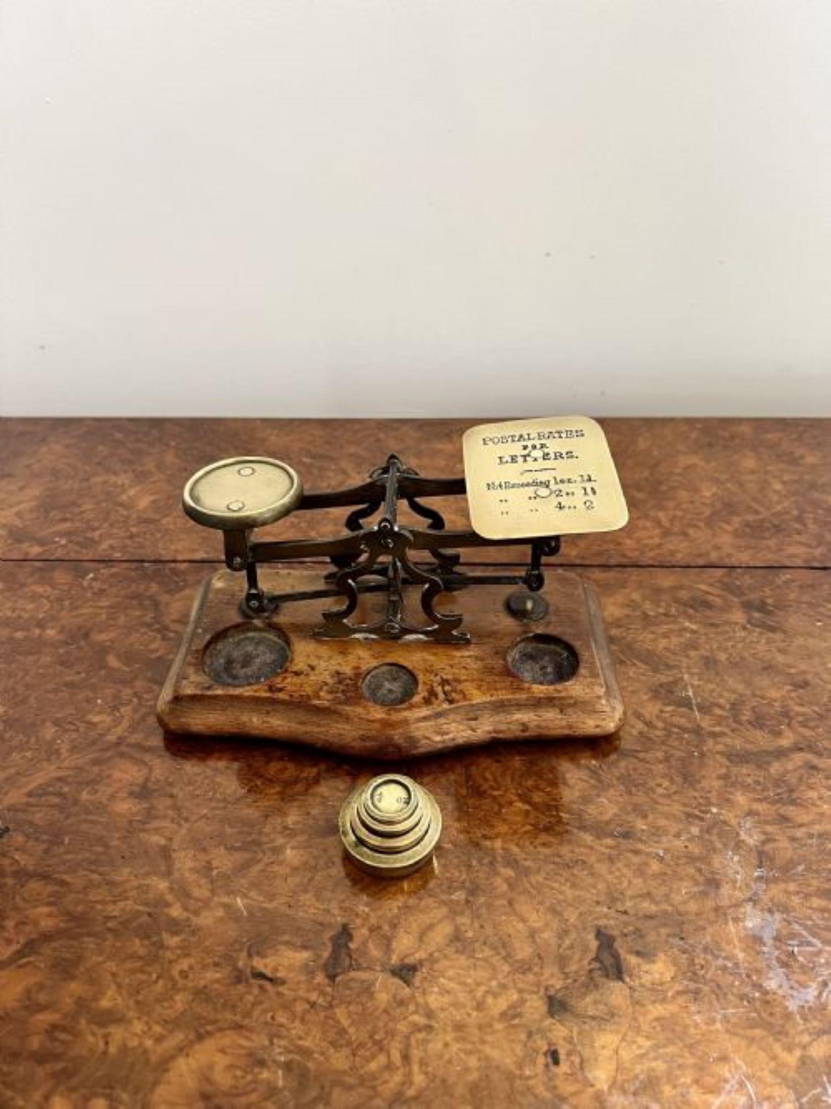 Lovely pair of antique Victorian quality brass postal scales having a lovely pair of antique Victorian brass postal scales with brass weights mounted on a wooden shaped base.