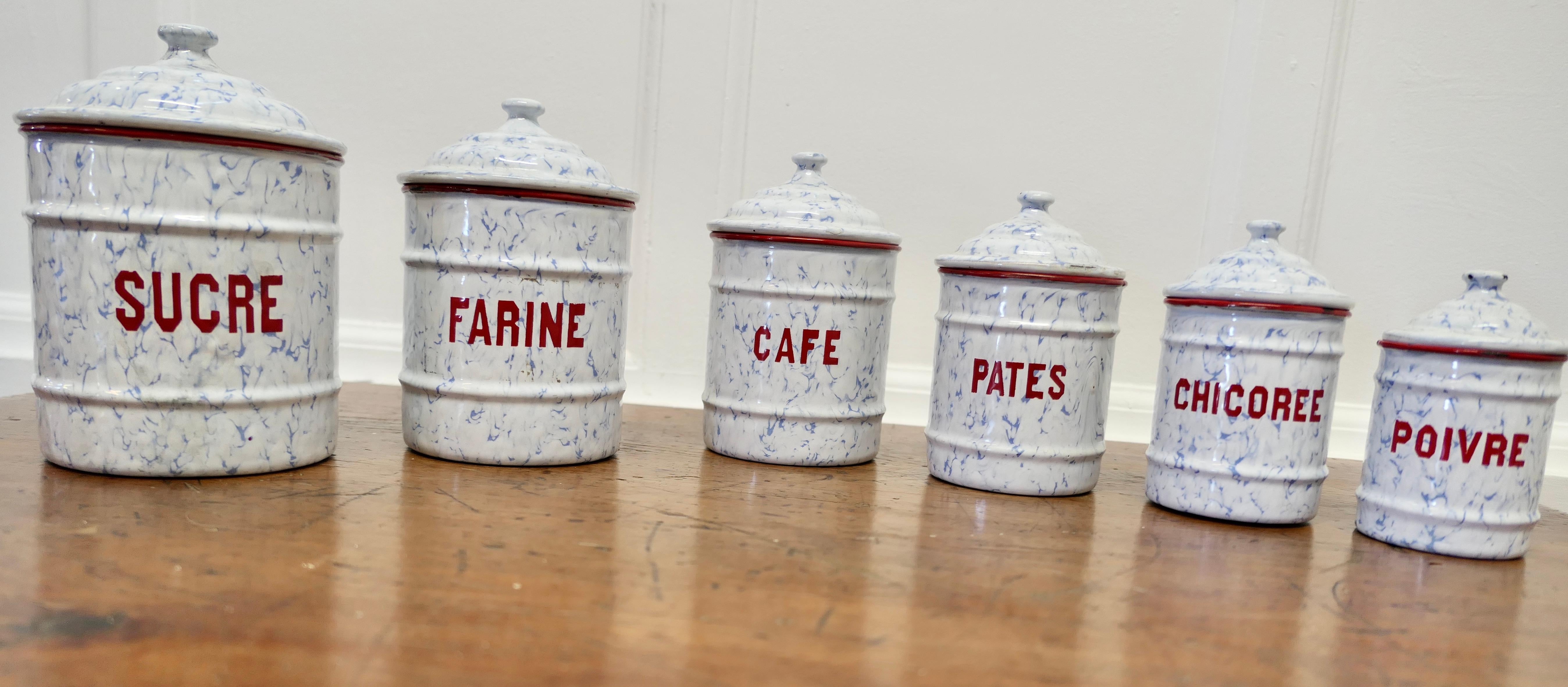 Lovely Set of French Enamel Food Canisters

Original French Enamel Canister set is a complete set of six pieces with lids, Sucre, Café, Farine, Pates Chicoree and Poivre. The canisters are attractively shaped they have Red lettering on a simulated