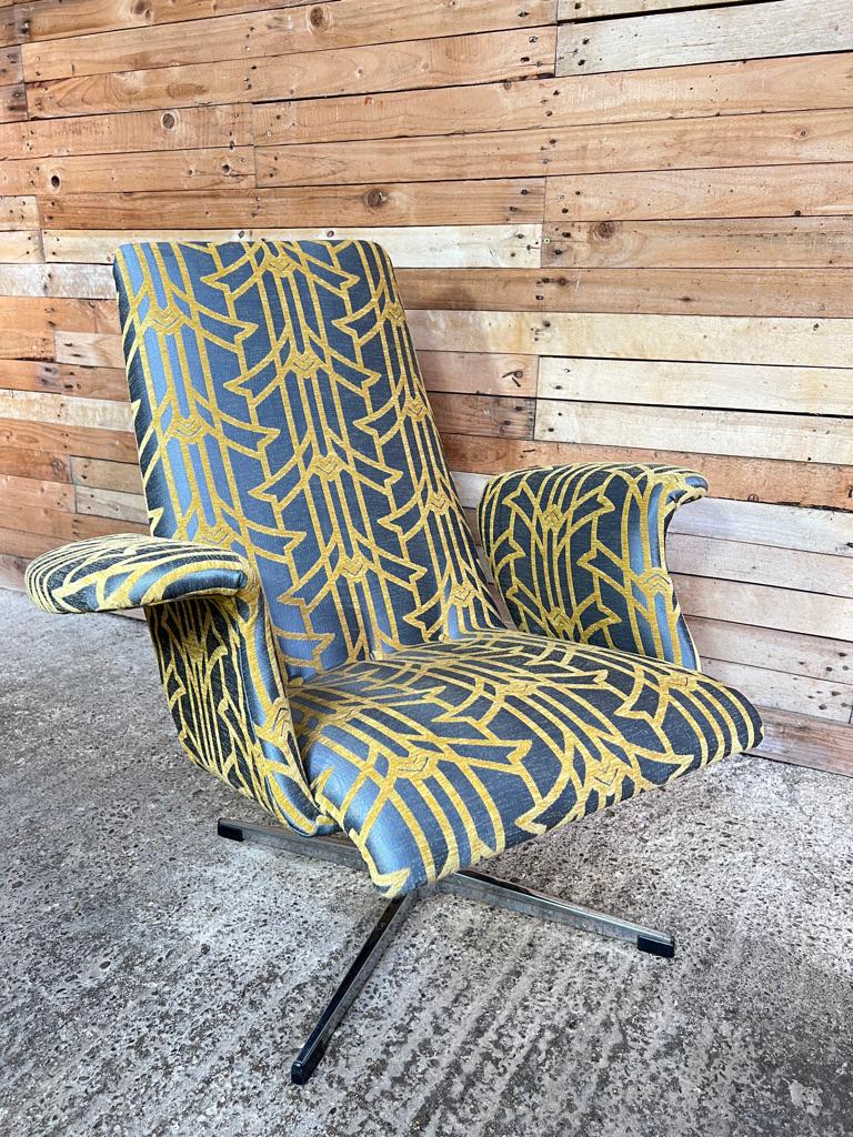Lovely shaped retro 1950's vintage 'Swan' arm chair very unusual shape. Newly upholstered in a light blue and gold coloured fabric, this chair will lighten up any room.

Measurements seat height 37cm, back height 86cm, depth 75cm, width 86cm.