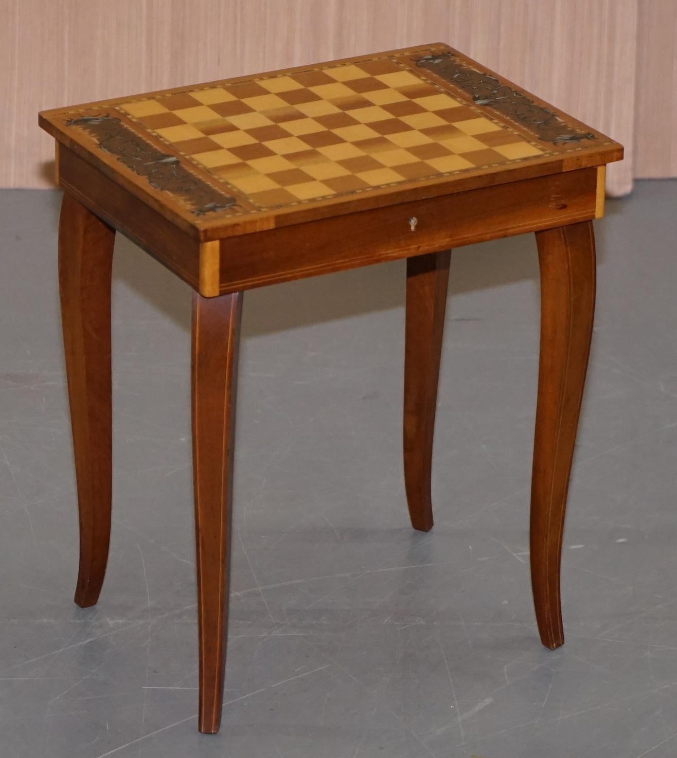 We are delighted to offer for sale this lovely little musical chess backgammon games table with original pieces

A good looking side table, very decorative, you have a full size drawer for storing games pieces in and of course the little music box
