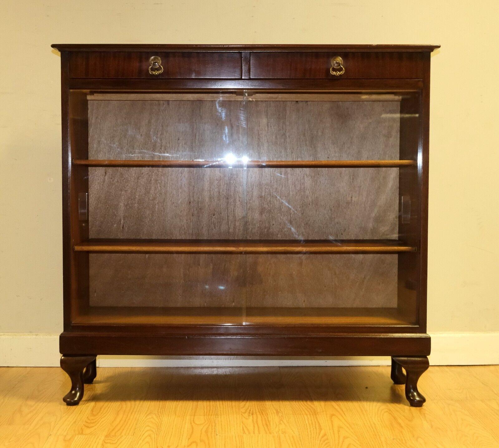 We are delighted to offer for salr this lovely Vintage Strongbow display cabinet with a pair of drawers on raised cabriole legs.

This well made and stylish display cabinet comprises a pair of sliding glass doors and two good size shelves. There is