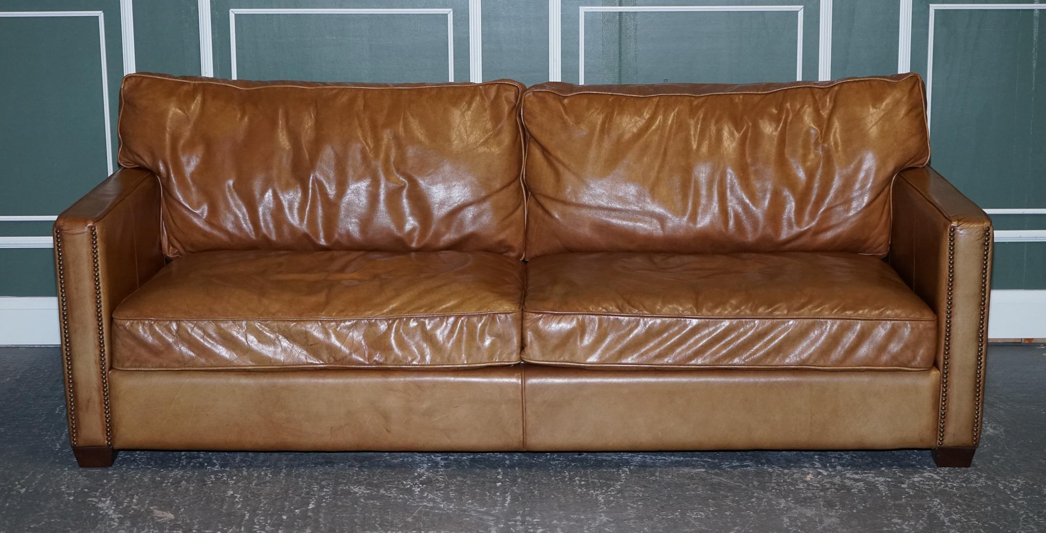 We are delighted to present this stunning vintage timothy oulton viscount tan leather sofa.

A very comfortable and generous-sized sofa, the cushions are still very plump and have plenty of life left in it. The arms on both sides can come off and