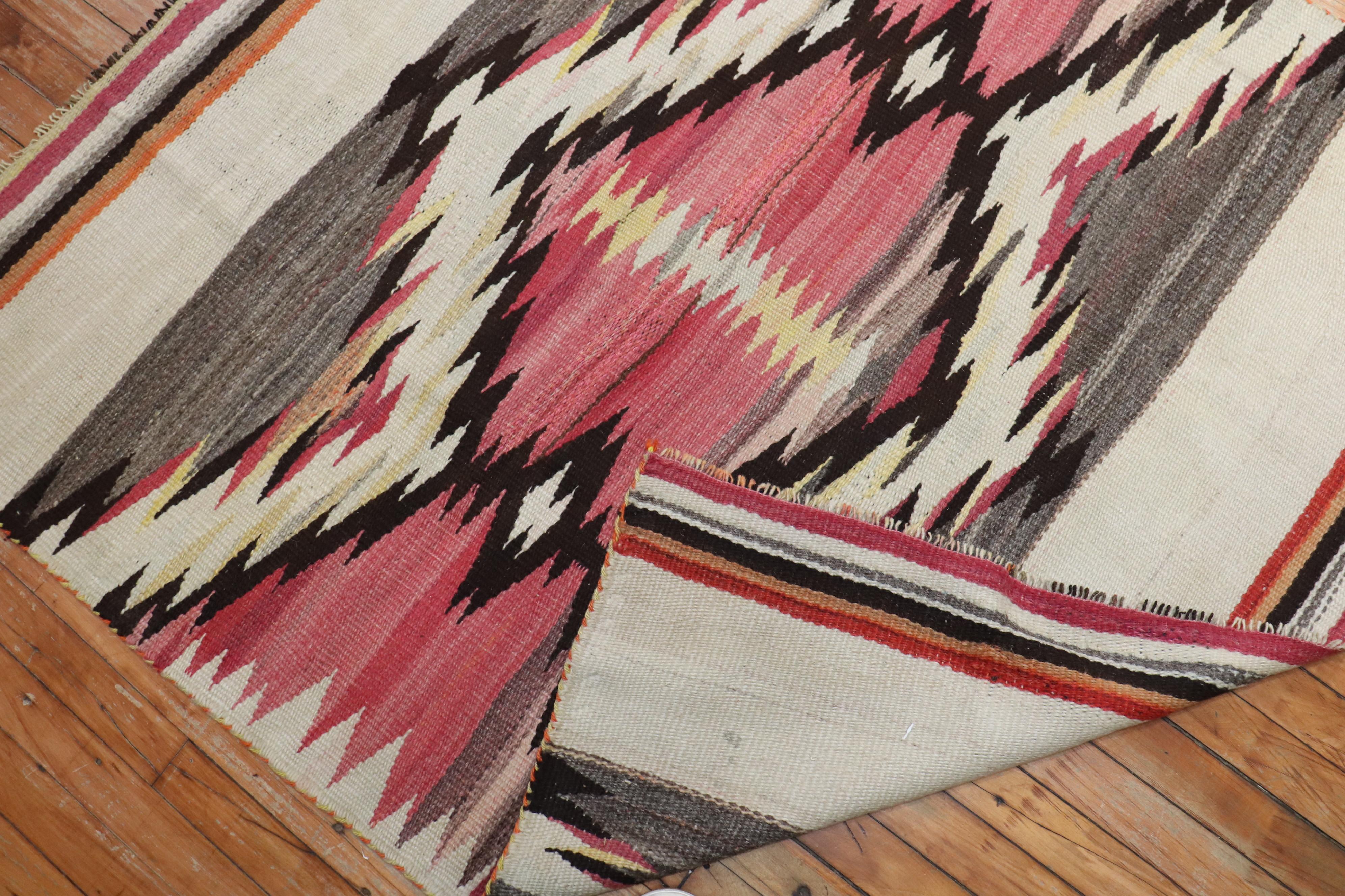 An early 20th century high decorative American Navajo rug featuring a tribal design in gray, pink, ivory, and brown


Measures: 4'2