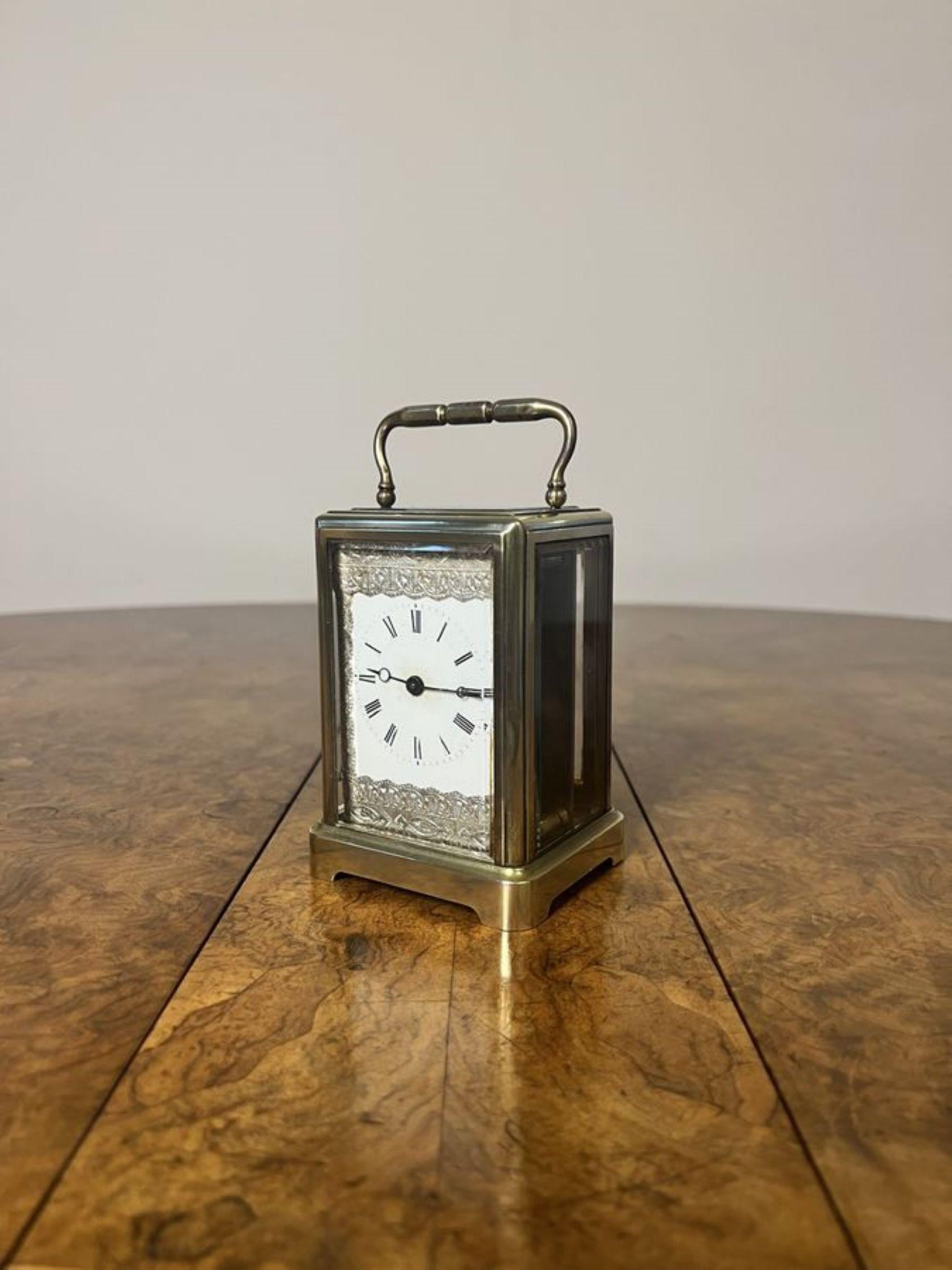 Lovely unusual antique Edwardian brass carriage clock having a unusual antique brass carriage clock with a handle to the top and a visible platform escapement, having a white enamelled dial with Roman numeral and the original hands within a ornate