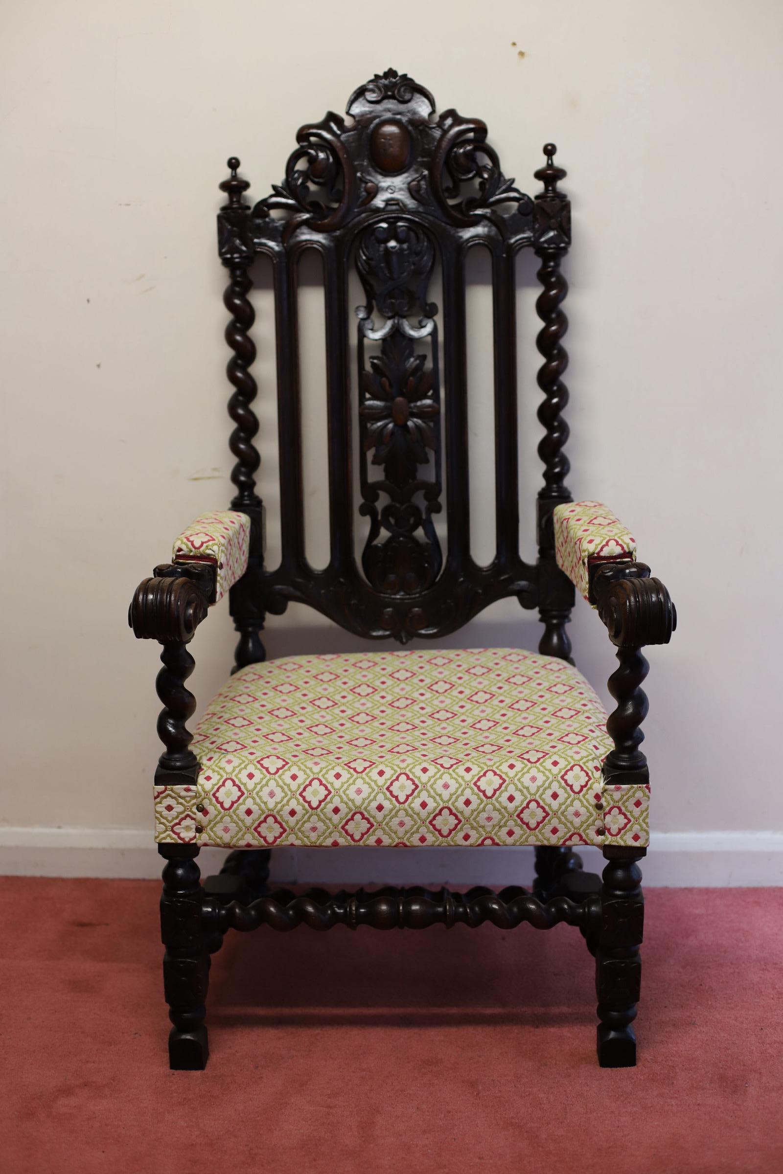 We delight to offer for sale this amazing 19th century oak armchair. The arched back with turned finials and heavily carved with flowers, scrolls and shells, flanked by turned twist supports, the carved legs united by twist supports, the elbow rests