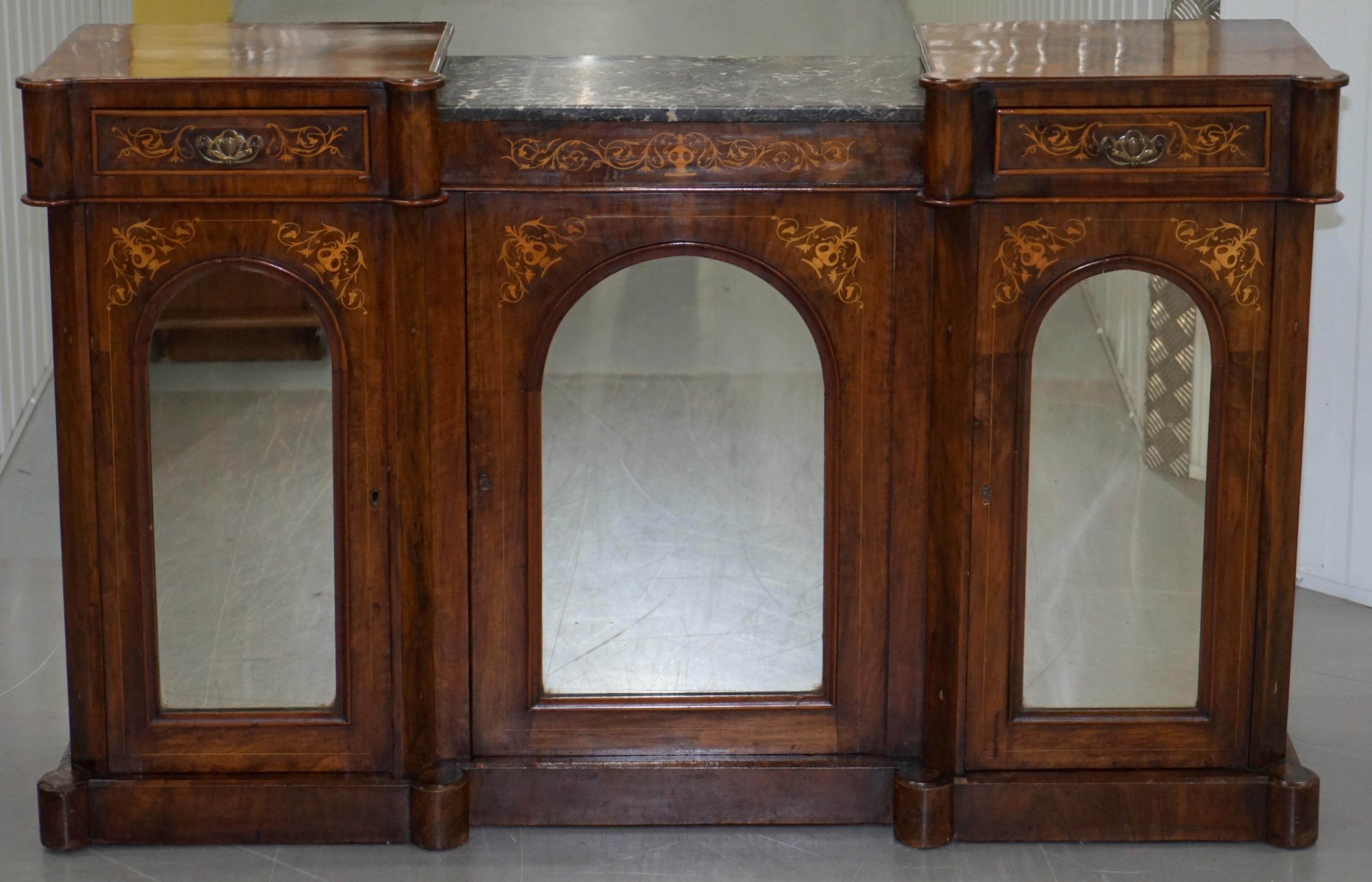 We are delighted to this lovely Victorian walnut with marquetry inlaid credenza with marble top and mirrored doors

This piece is very decorative and sculptural, the timber patina is glorious, its quarter cut walnut and has a lovely warm glow to