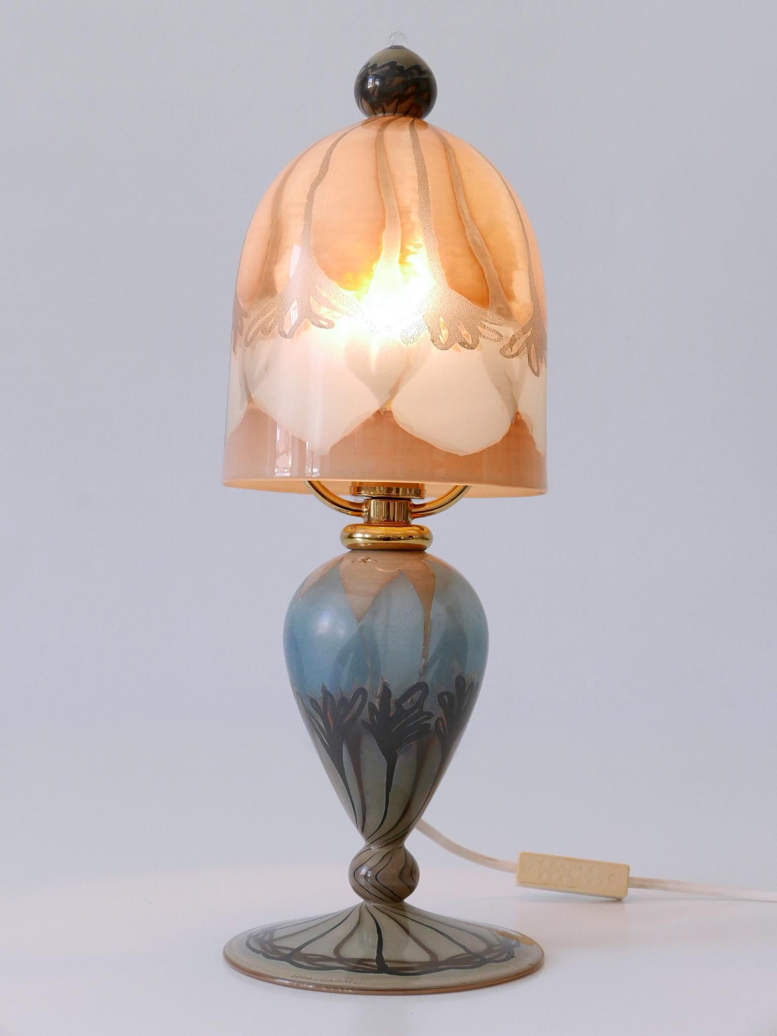 Elegant and highly decorative vintage table lamp or bedside table lamp. Designed & manufactured in Germany, 1980s. Signed on the base: Vera Walther

Executed in colored art glass and polished brass, the table lamp is executed with 1 x E14 / E12