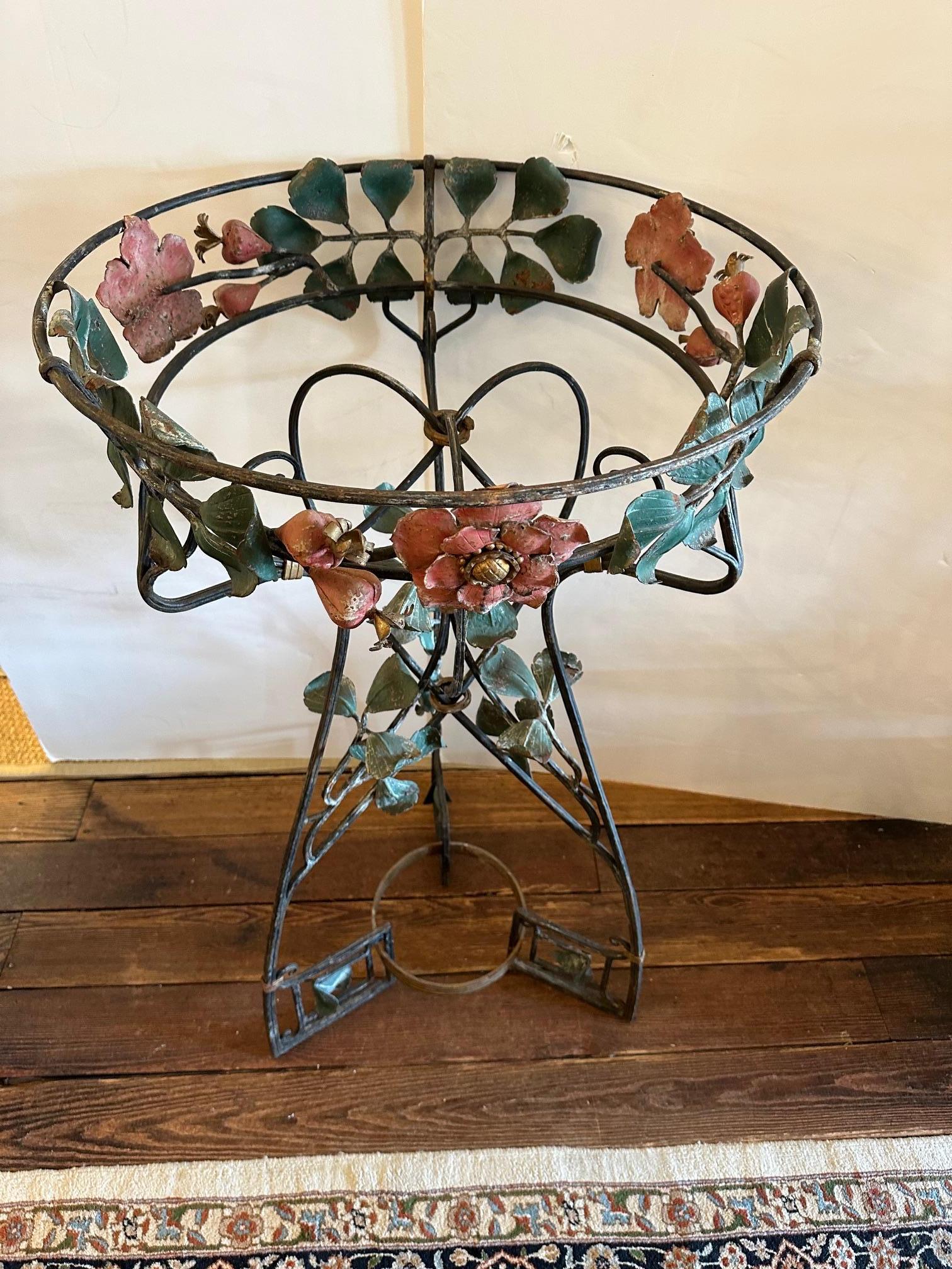 Lovely vintage Art Nouveau iron plant stand having floral decoration.
