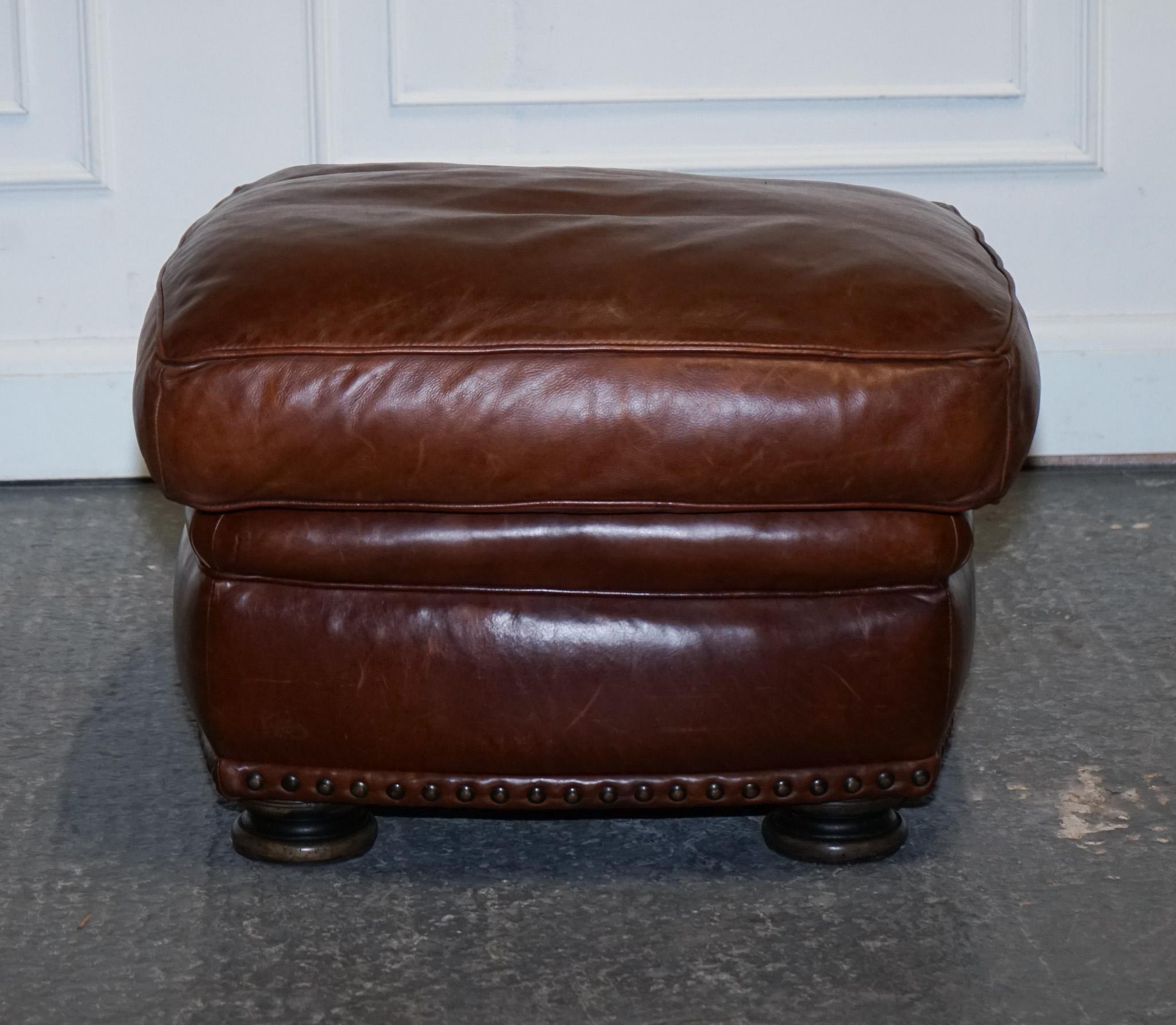 Leather LOVELY VINTAGE BROWN LEATHER FOOTSTOOL FEATHER FILLED BRASS STUDS DETAiL For Sale