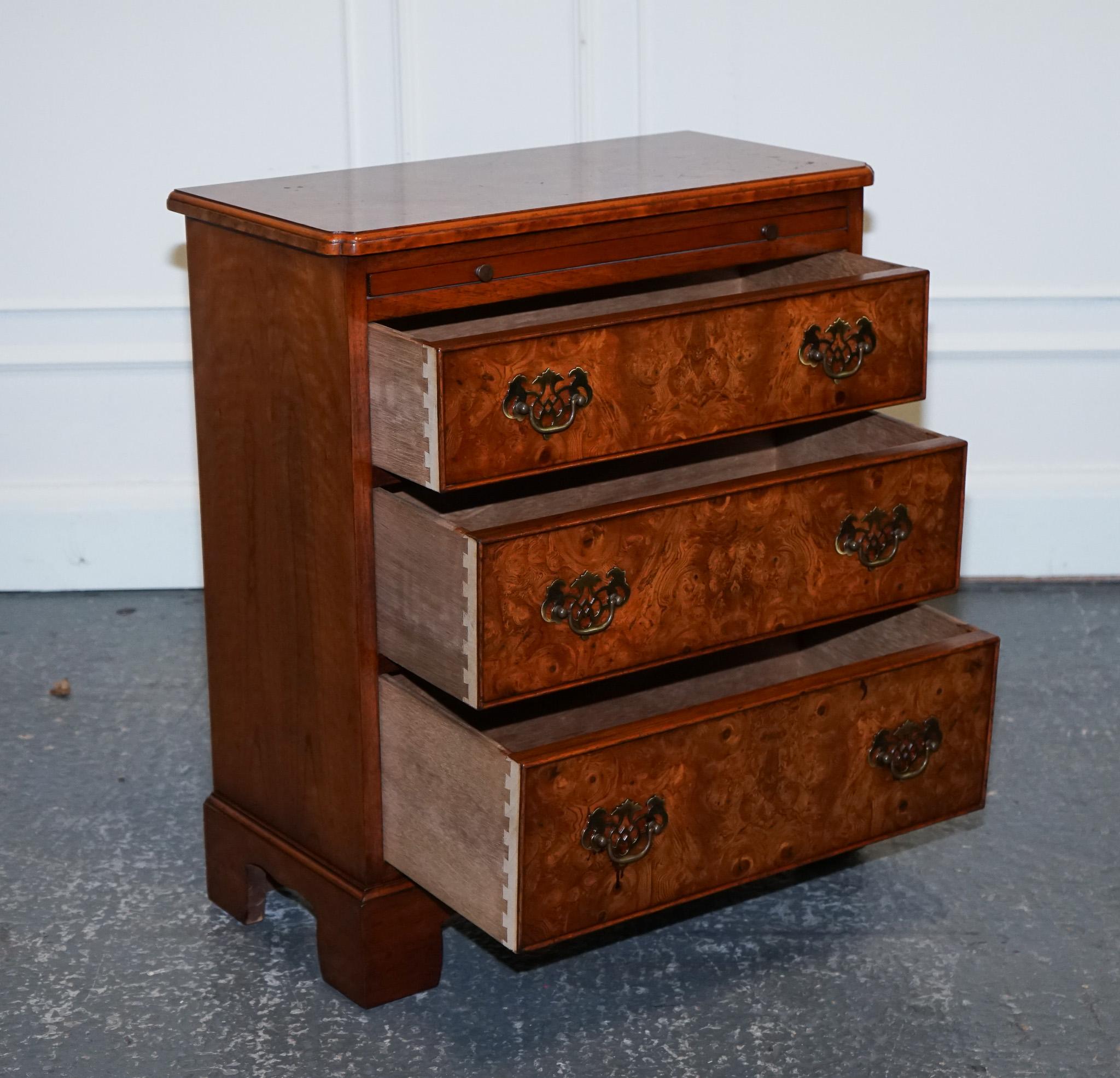 
We are delighted to offer for sale this Lovely Vintage Burr Walnut Chest Of Drawers.

A lovely vintage burr walnut bachelor's chest of drawers with a butler slide is a timeless piece that exudes elegance and charm. Crafted from rich and warm burr