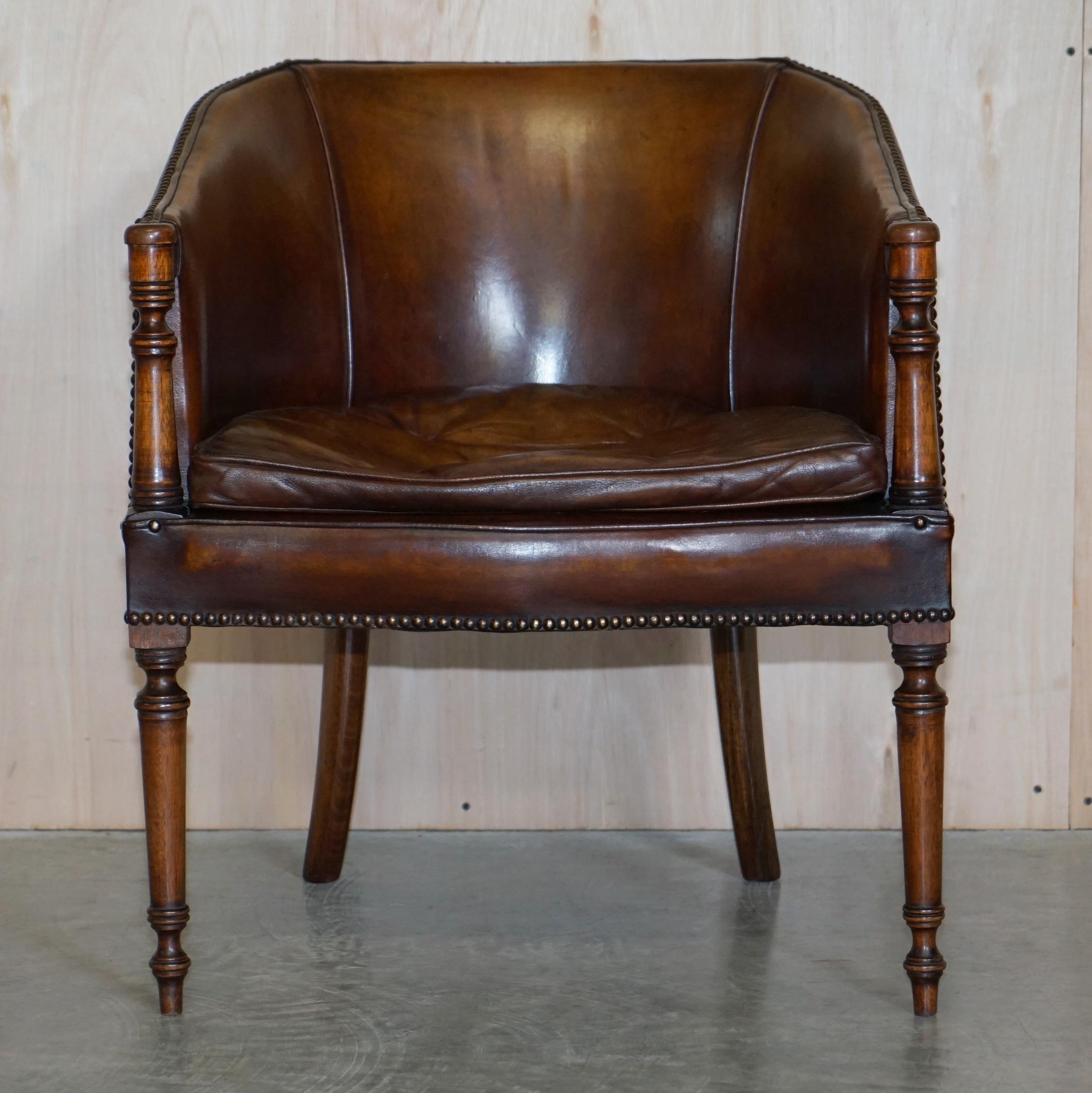 We are delighted to offer for sale this lovely vintage hand dyed brown leather tub armchair with Thomas Chippendale style floating buttons to the cushion

This piece is very decorative, the legs and arm panels are beautifully carved and nicely