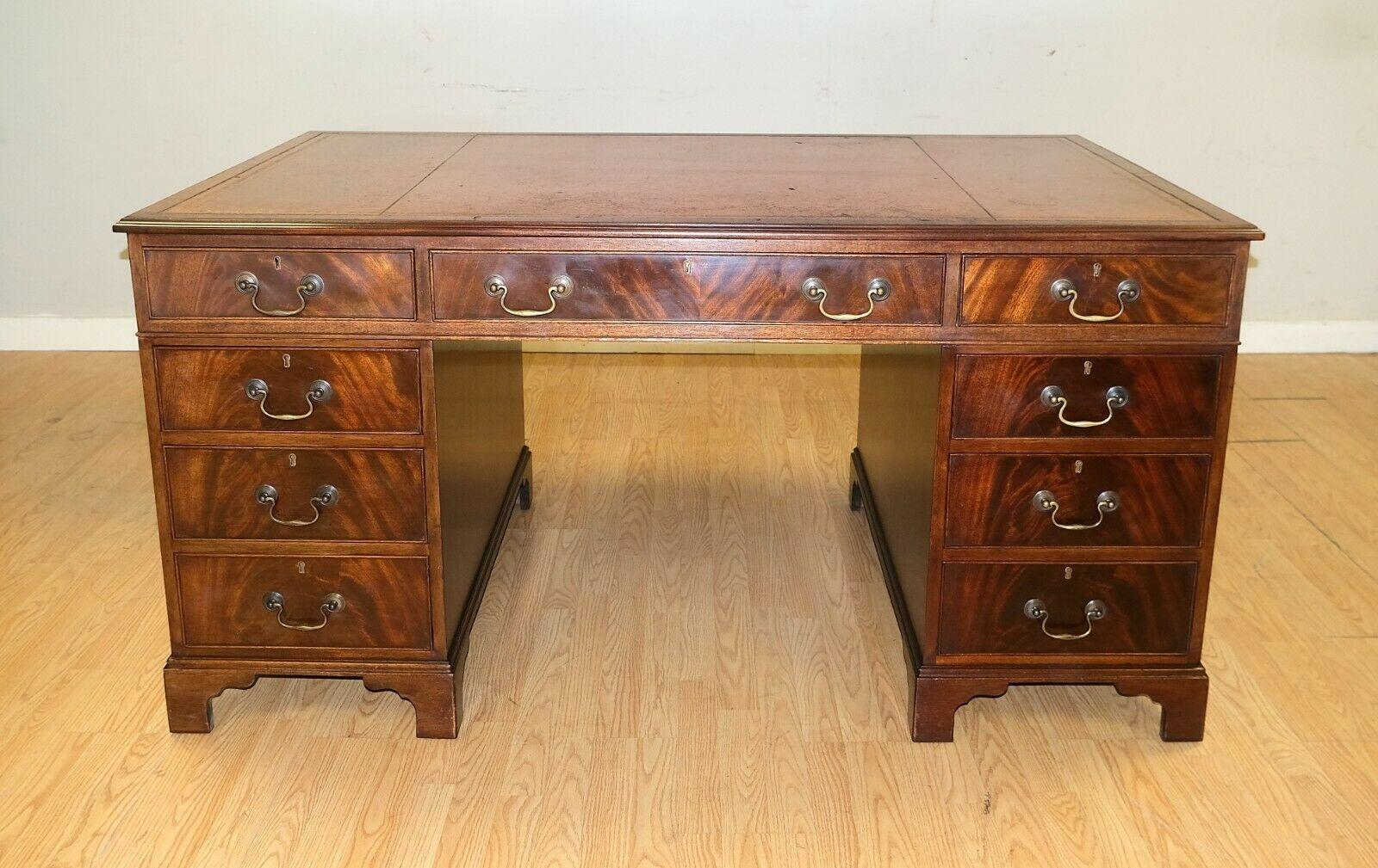 We are delighted to offer for sale this lovely Vintage twin pedestal partner desk with keys and brown leather top.

This solid and well made desk offers you twelve drawers and a pair of good size cupboards. This type of desk was naturally designed