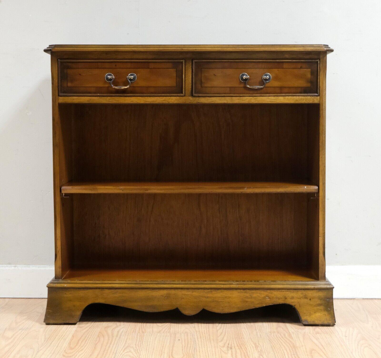 We are delighted to offer for sale this charming vintage Yew wood dwarf open bookcase with a single adjustable shelf. 

This lovely piece is well presented with a pair of good-sized drawers for storage and an adjustable single shelf. It is a well