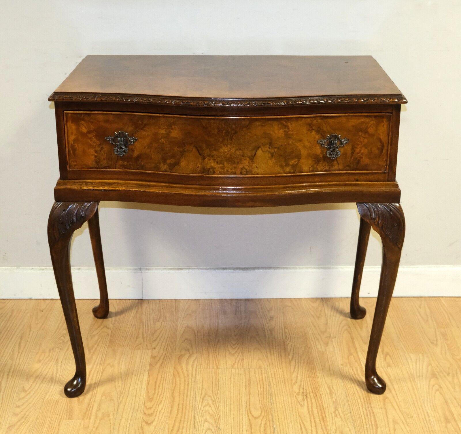 We are delighted to offer for sale this lovely Burr Walnut console/side table on Queen Ann style legs and single drawer. 

This gorgeous and well made piece is presented with a beautiful serpentine front and hand carved edge. The table is raised