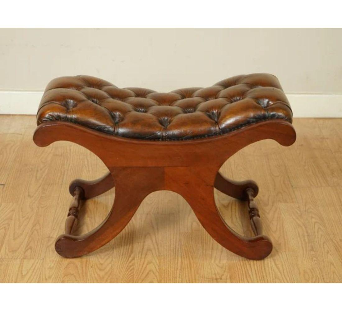 We are delighted to offer for sale this gorgeous whiskey brown restored hand hyed chesterfield footstool.

As mentioned, this footstool is fully restored, our polishers have hand dyed this amazing one-off whiskey brown color, and the wood has been