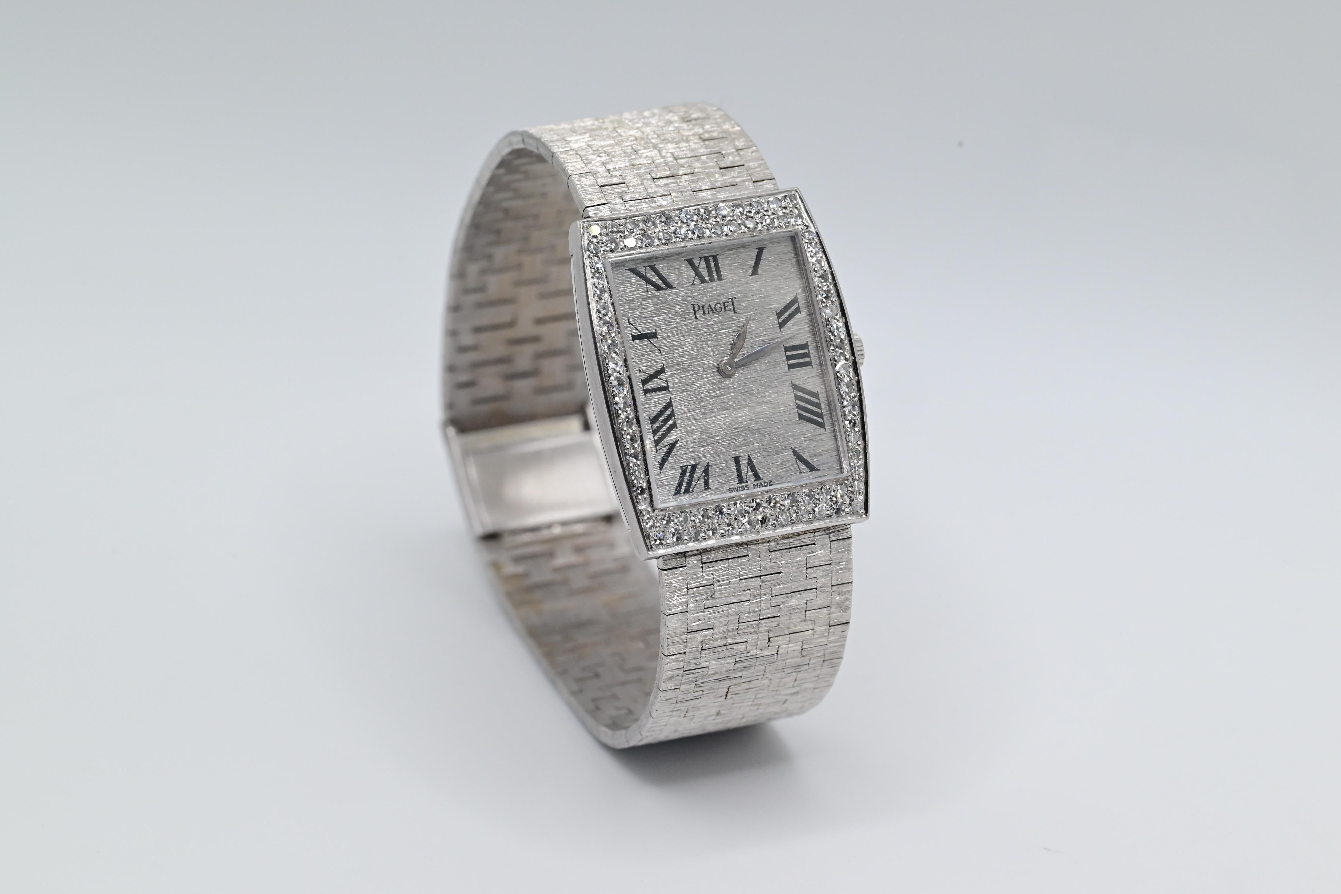 Description & Features: Piaget Gold & Diamond Wristwatch Ref 9675


18 Karat White Gold, Manual Mechanical, Rectangular Shaped Case Brushed


Gray Tone Dial With Black Roman Numeral Dial, 48 Round Shaped Natural Diamonds


Approx 1.5-2 Carat Total