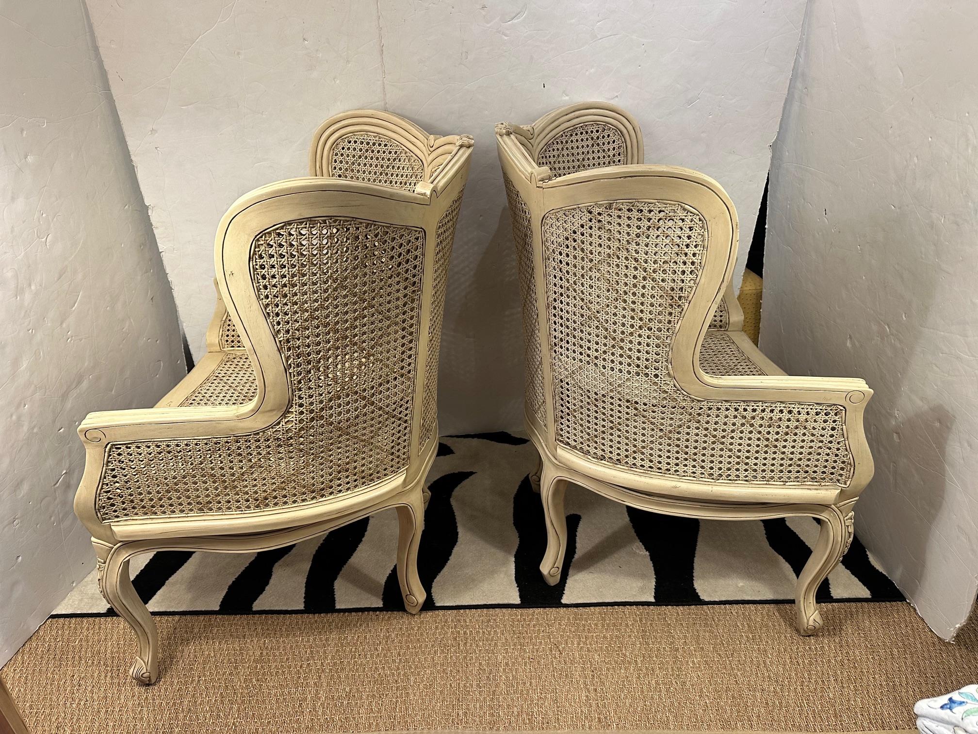Lovely French double caned wingback chairs painted a neutral cream.
Arm 26.75” H
Seat 17.5” H x 24” D