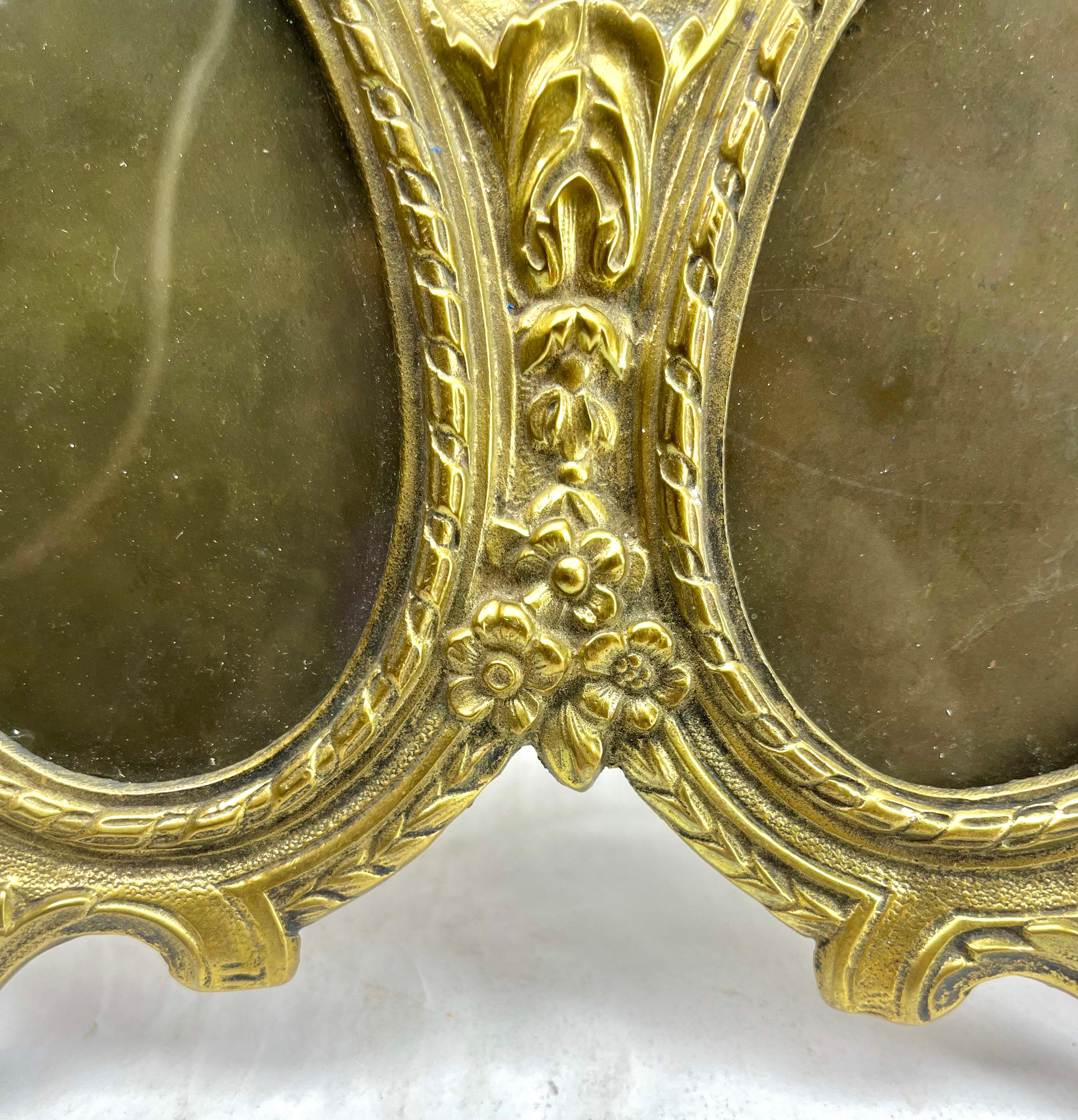 Original Victorian period double photograph frame (or miniature frame) with classical Victorian 'Lover's Knot' design. Typical frame for wedding photographs. Made of solid cast brass with a highly polished front surface.
Framed space for two