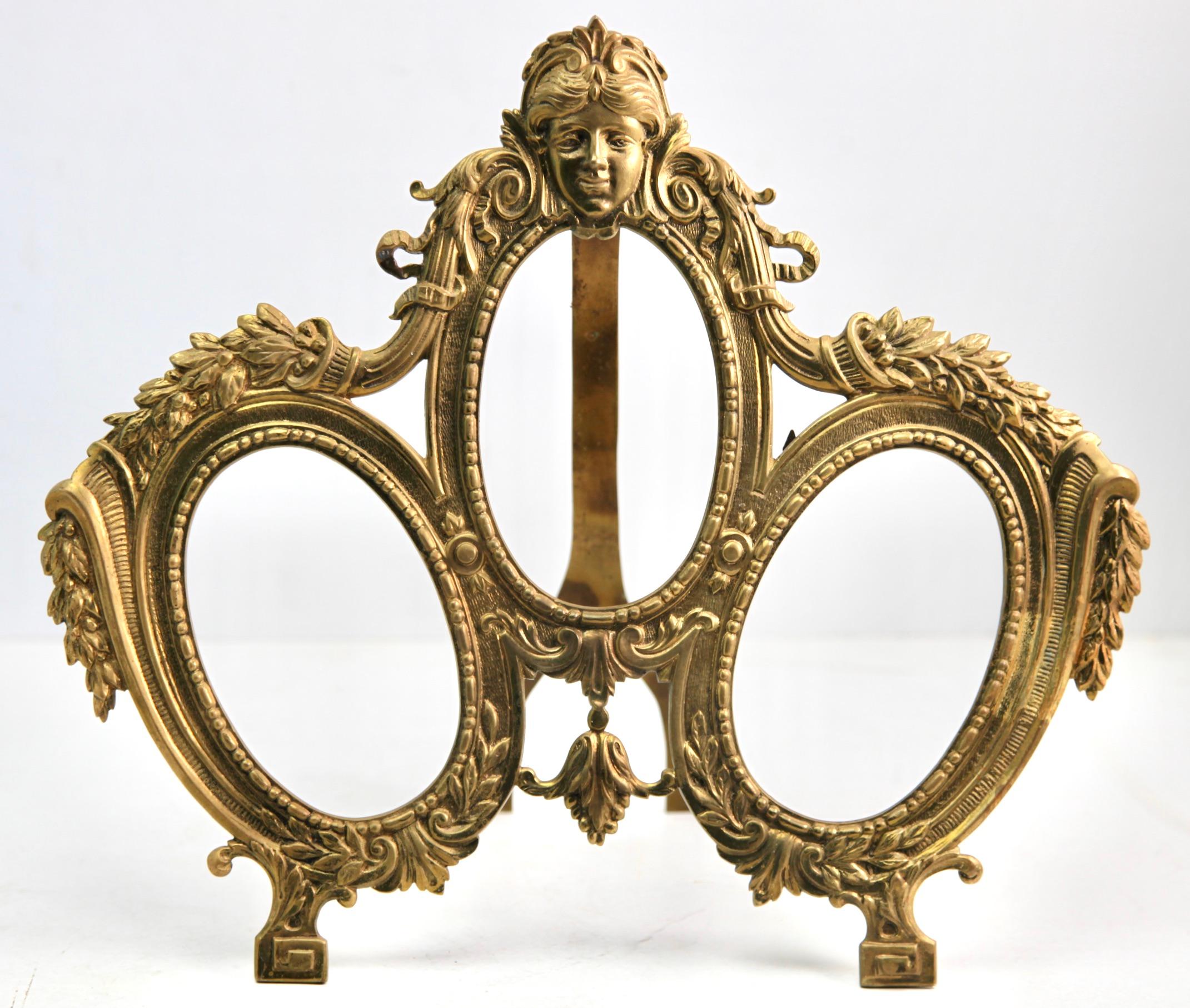 Original Victorian period triple photograph frame (or miniature frame) with classical Victorian 'Lover's Knot' design. Typical frame for wedding photographs. Made of solid cast brass with a highly polished front surface and glass front
Framed space