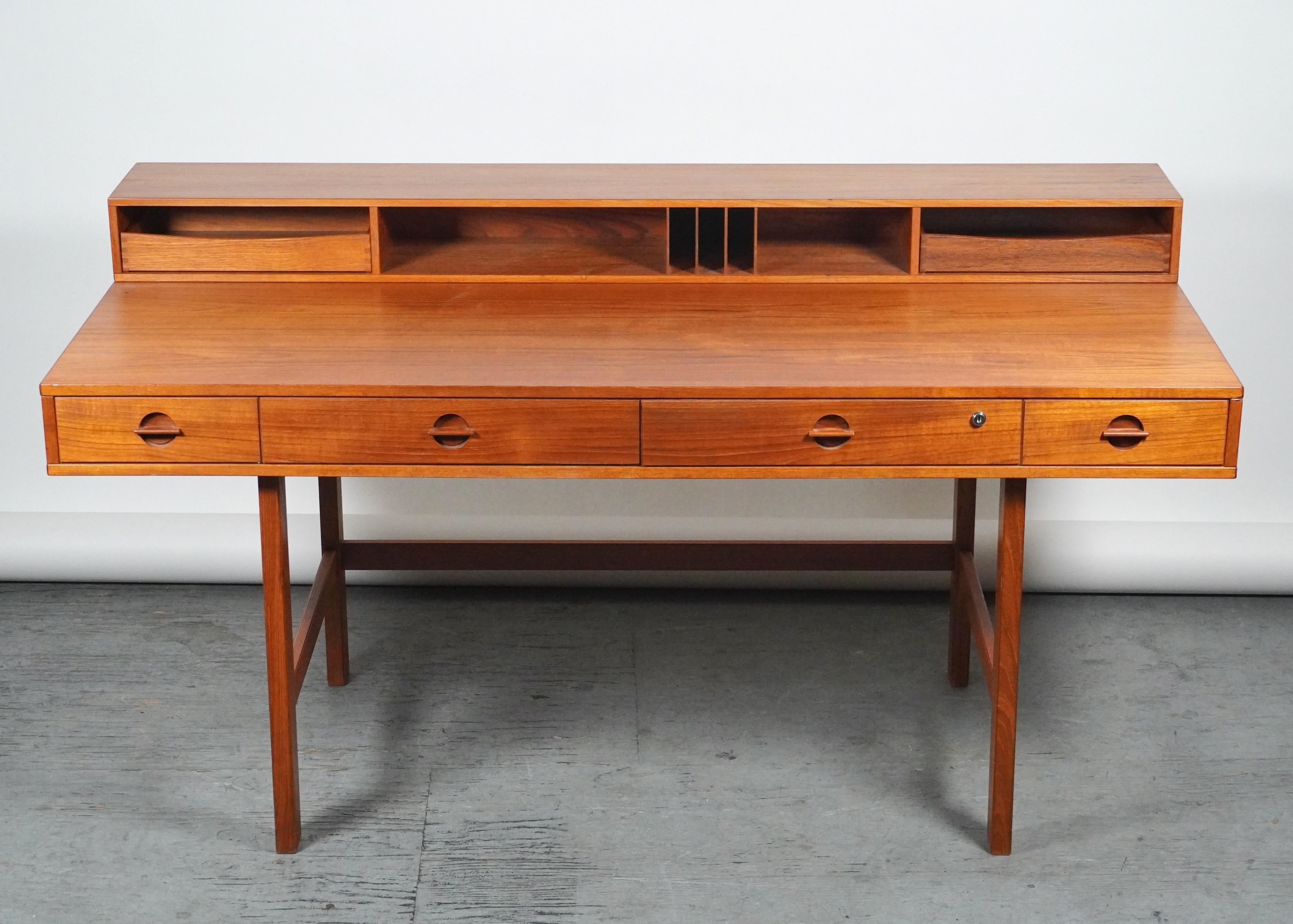 Teak Partners desk by Peter Lovig Nielsen, 1969. Gorgeous teak grain and all original brass hardware, this desk allows a flip down side and can be used as a partners desk as well as a larger single desk. Multiple storage compartments and all