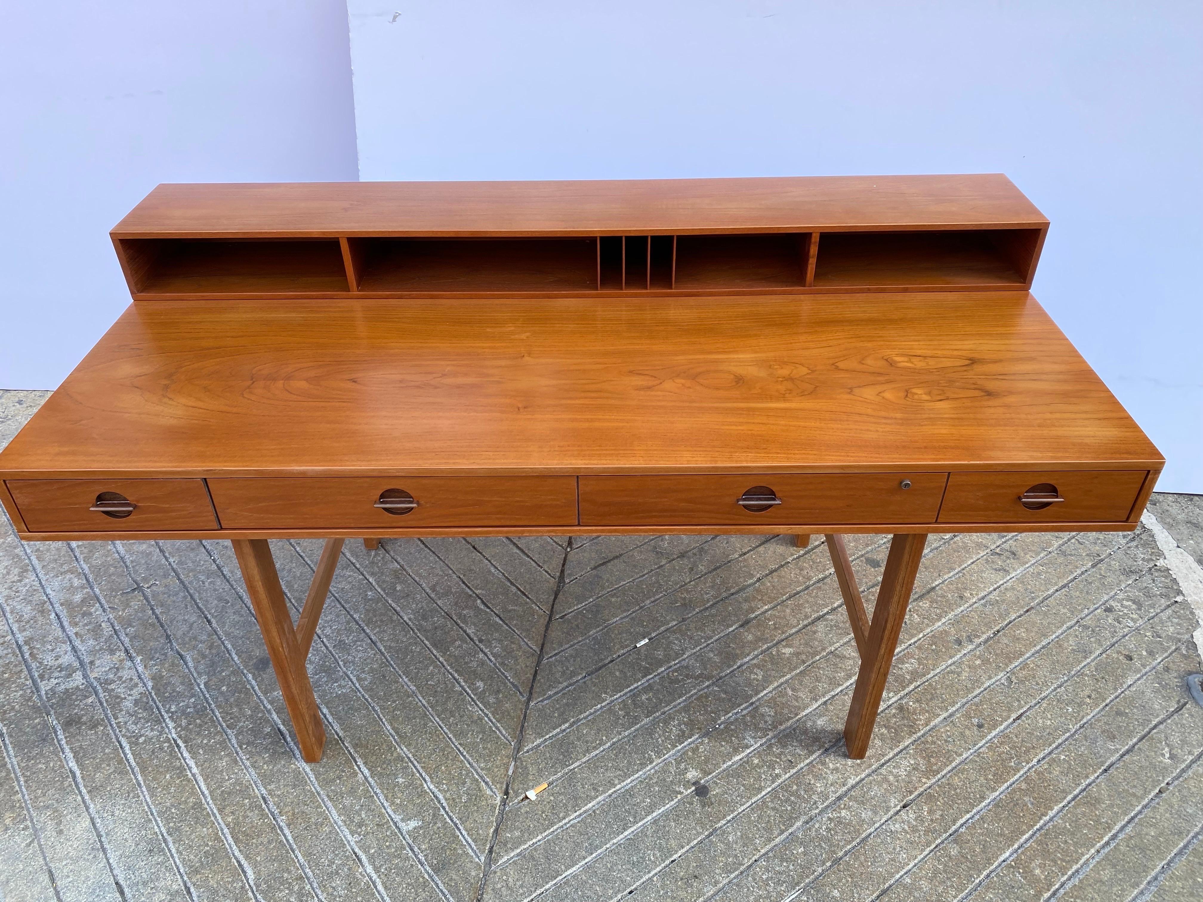 Newly refinished Lovig teak desk with cubby top that flips down to add another 9