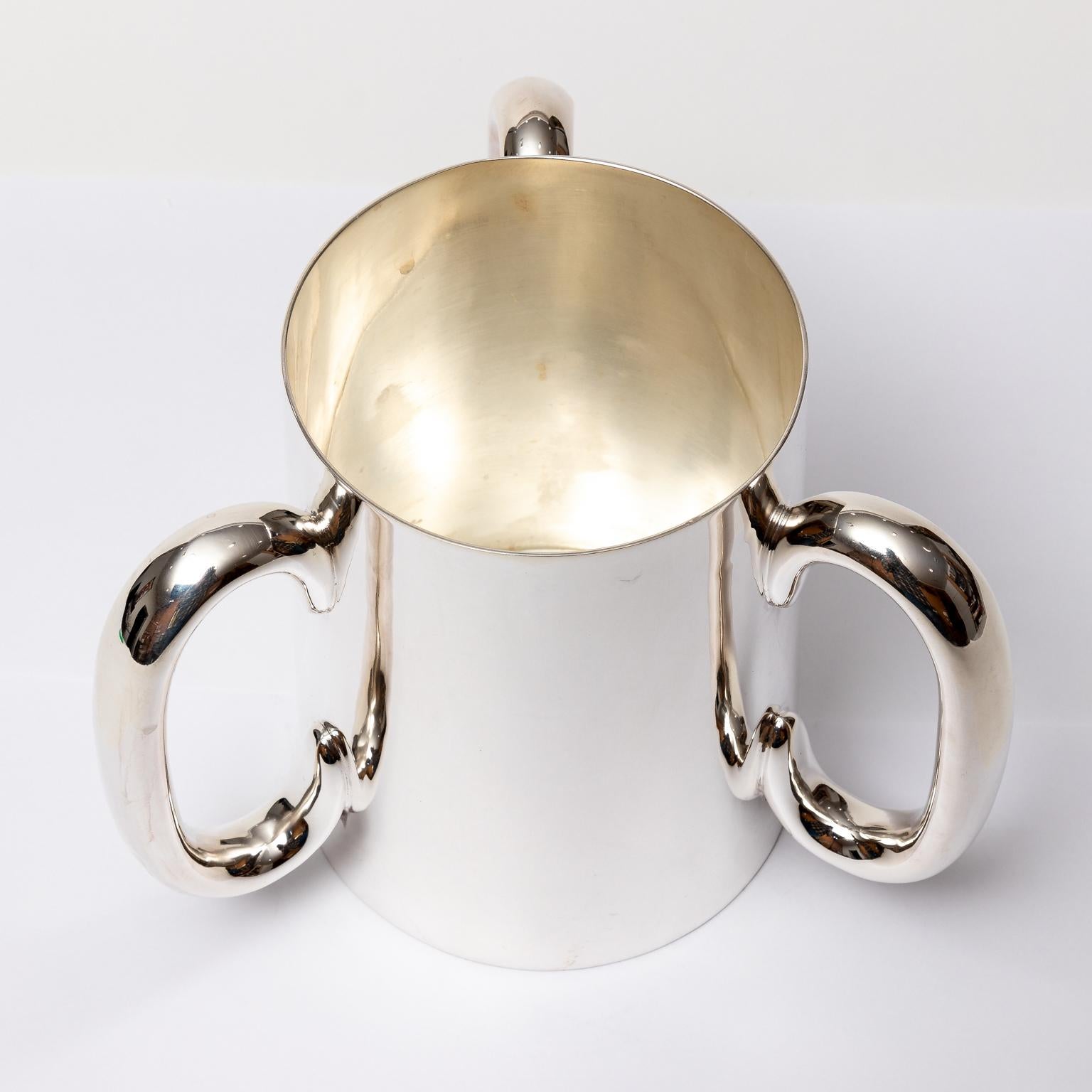 Circa 1930s English silver plate loving cup with tri handle. Made in England. Please note of wear consistent with age.