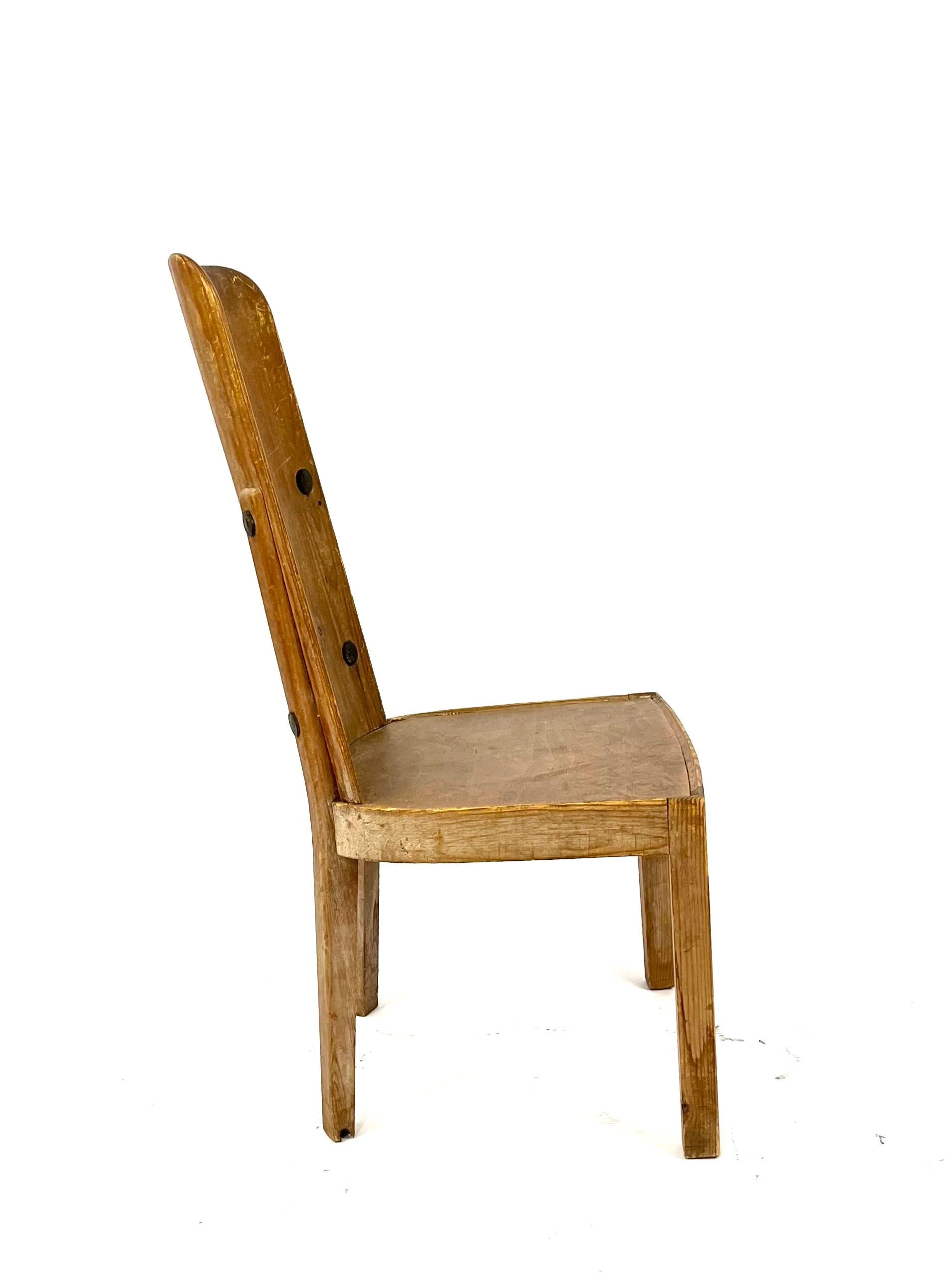 A stained pine 'Lovö' chair by Axel Einar Hjort for Nordiska Kompaniet, Sweden 1930s.

Iron mounts, high back. Height 95 cm, seat height 41 cm.

Wear and scratches.