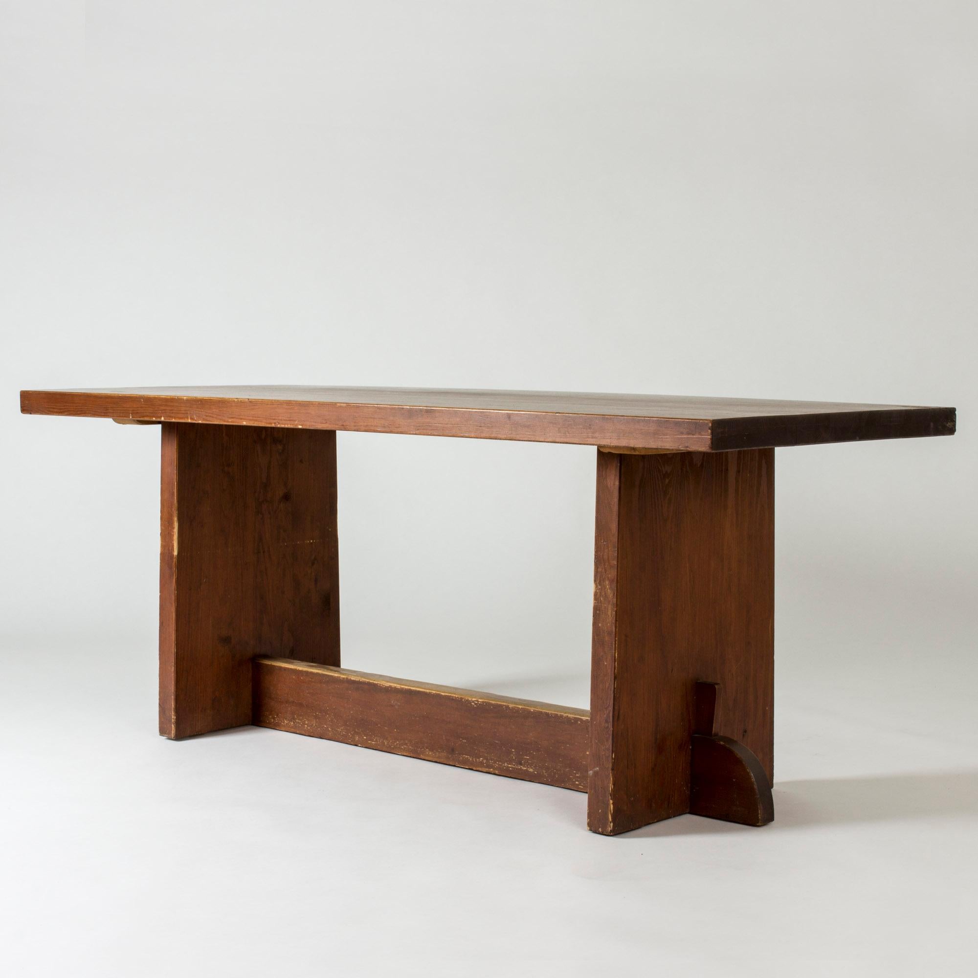 “Lovö” dining table by Axel Einar Hjorth, made from solid pine in a clean, rustic design. Stained darker brown.